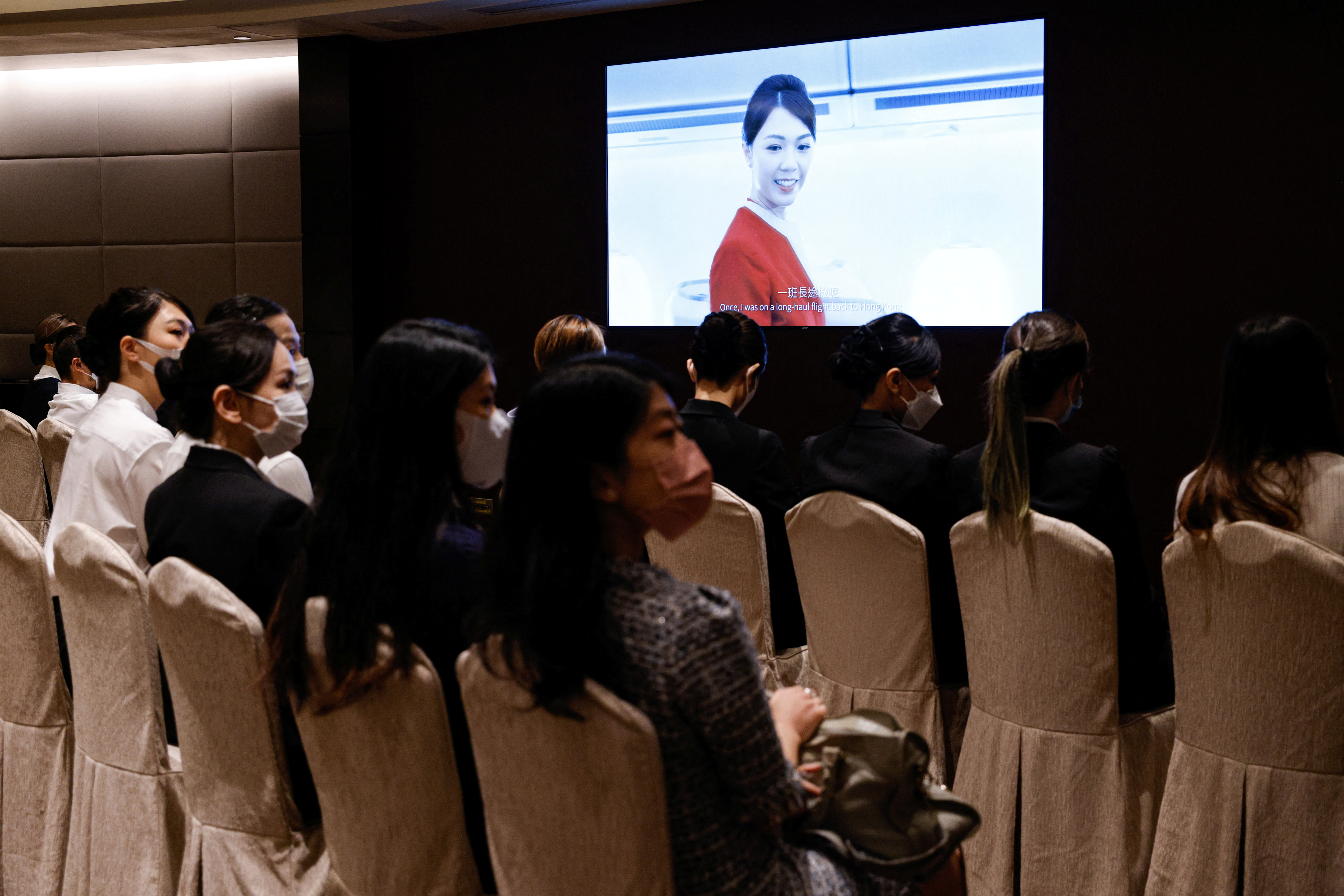 Applicants sit in a waiting room during the Cathay Pacific's flight attendants recruitment day, first time since the COVID-19 pandemic