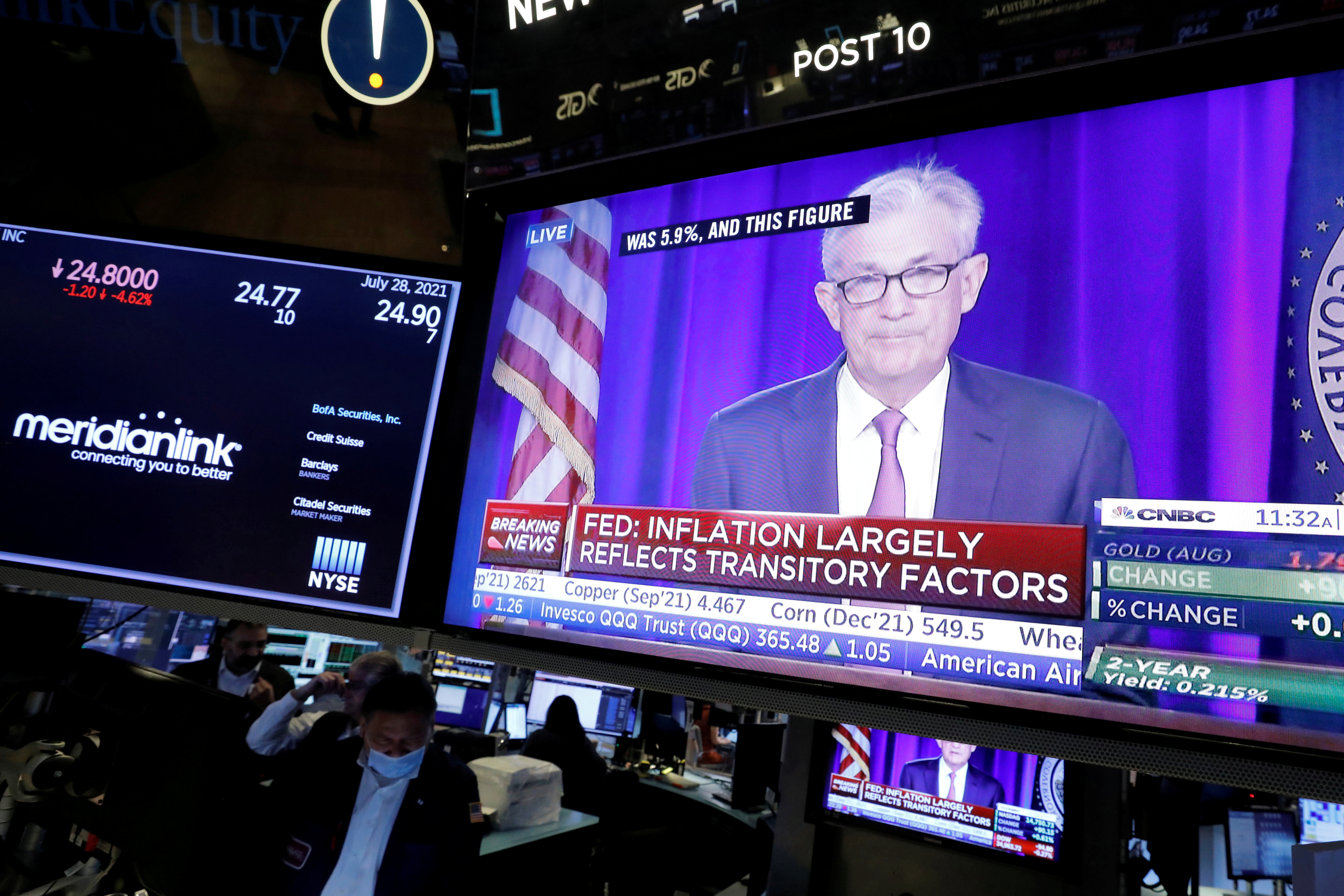 A screen displays a statement by Federal Reserve Chair Jerome Powell following the U.S. Federal Reserve's announcement as traders work on the trading floor at New York Stock Exchange (NYSE) in New York City, U.S.
