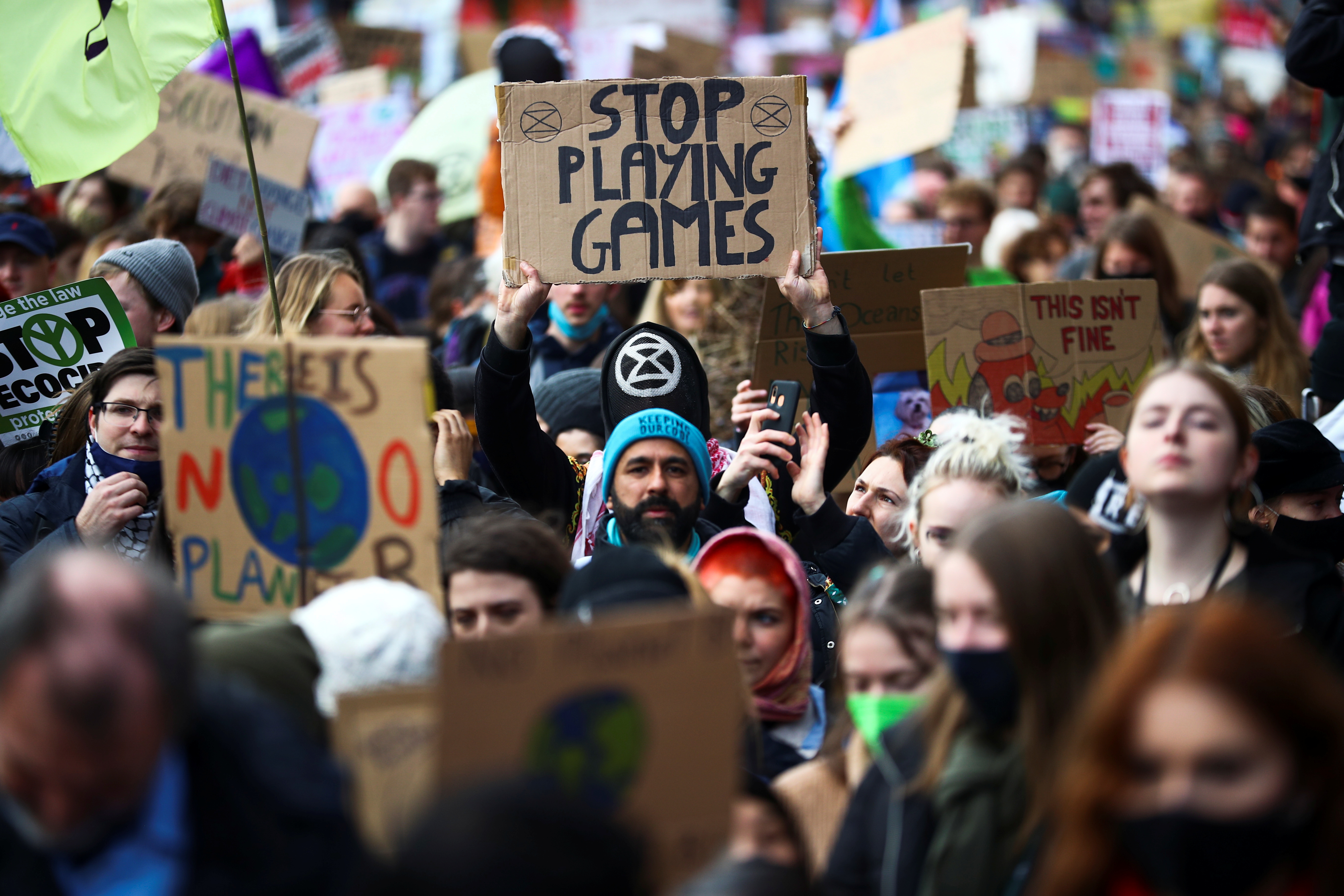Demonstrators hold placards at a Fridays for Future march during the UN Climate Change Conference (COP26), in Glasgow, Scotland, Britain, November 5, 2021. REUTERS/Hannah McKay