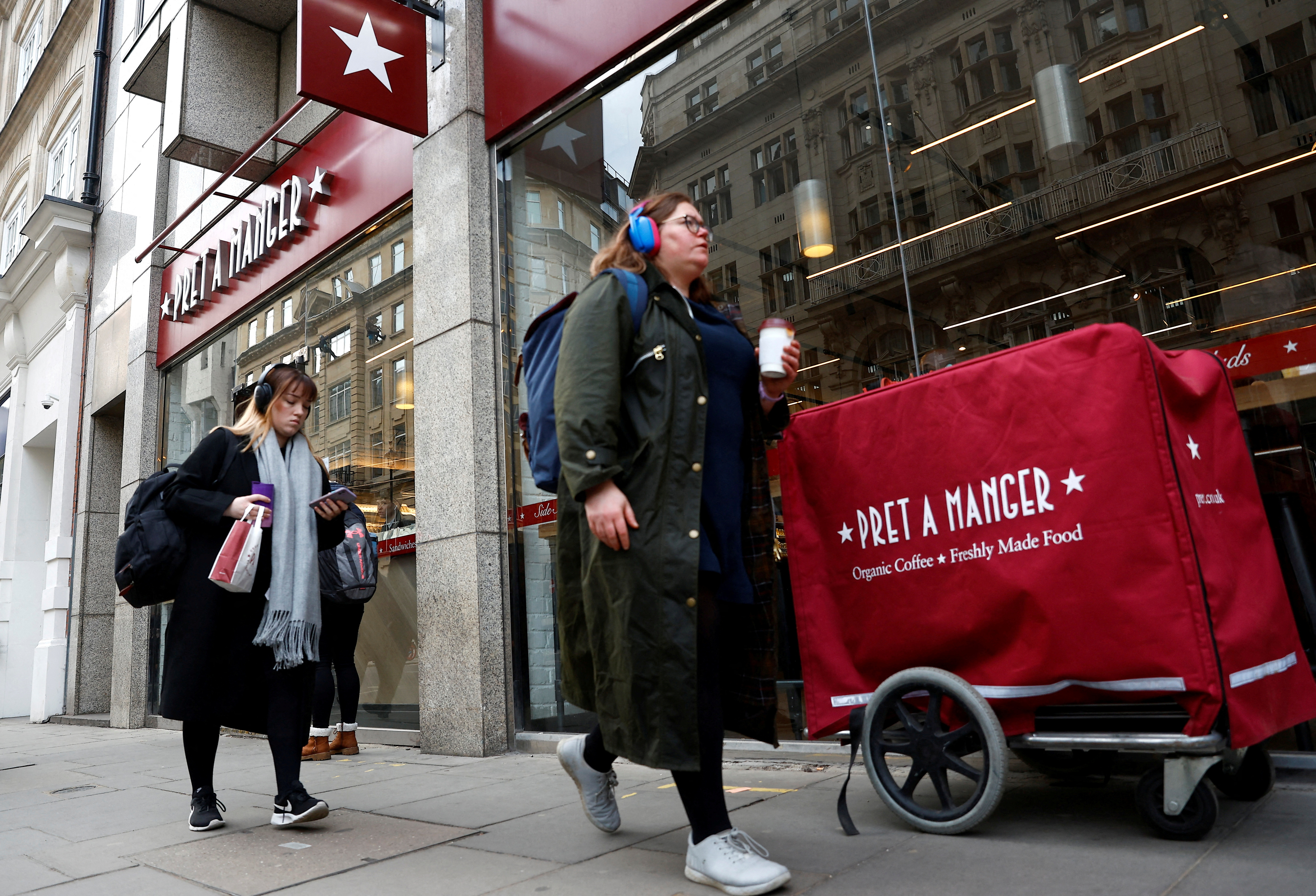 People walk past a Pret a Manger outlet in London