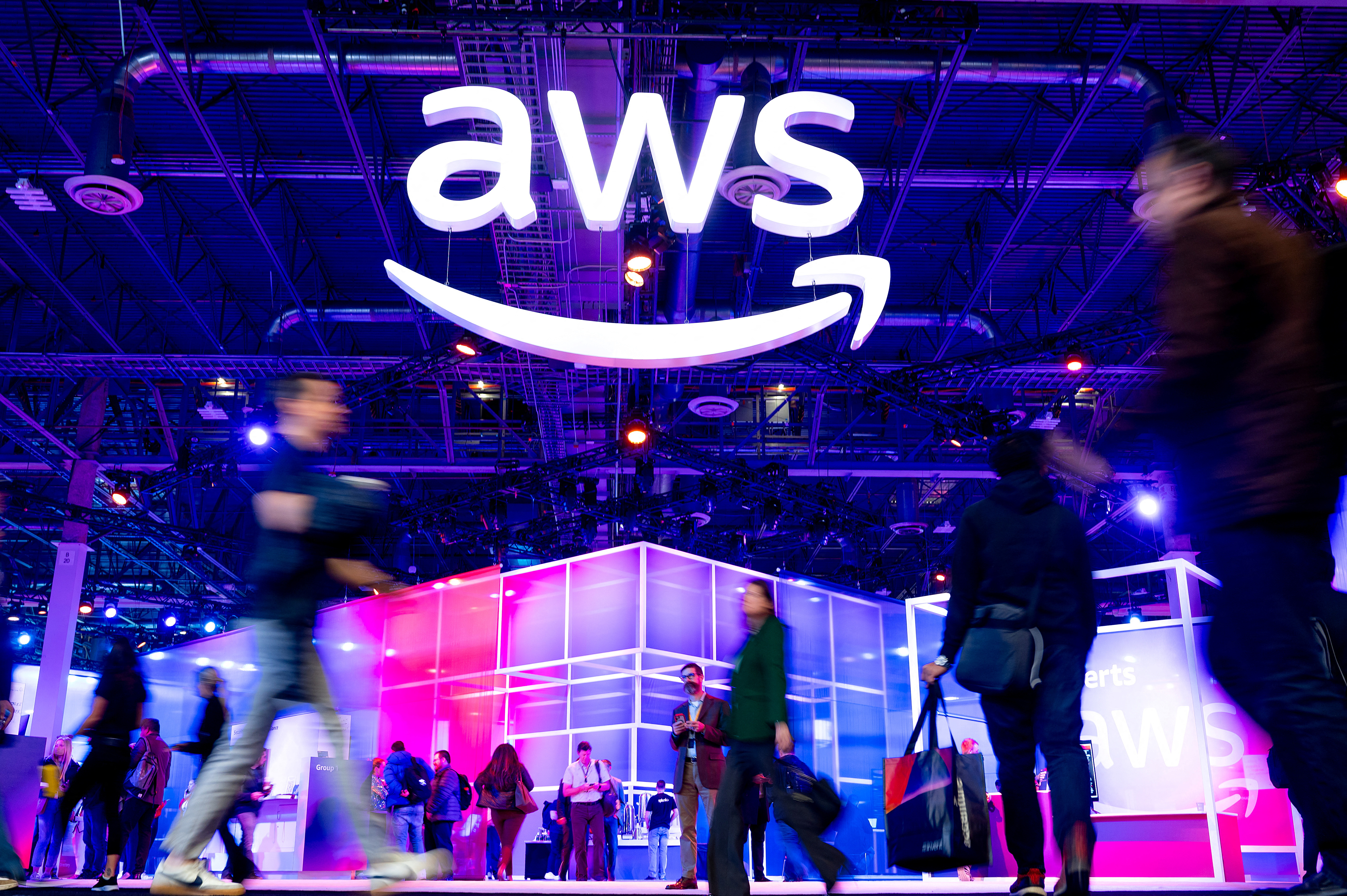 Attendees walk through an expo hall at AWS re:Invent 2023, a conference hosted by Amazon Web Services (AWS), in Las Vegas