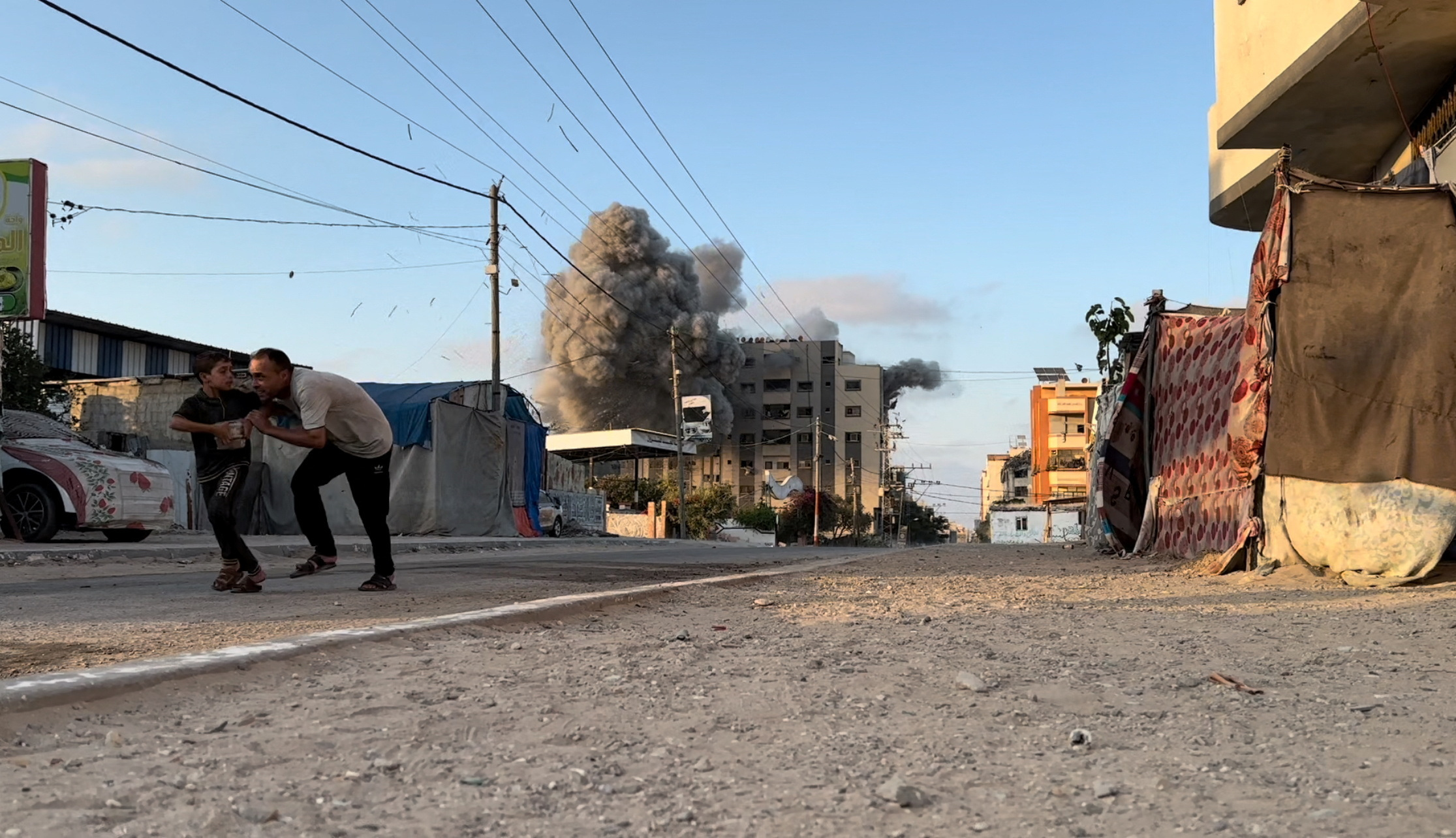 Smoke and flames rise following an Israeli strike on a residential building inNuseirat in the central Gaza Strip