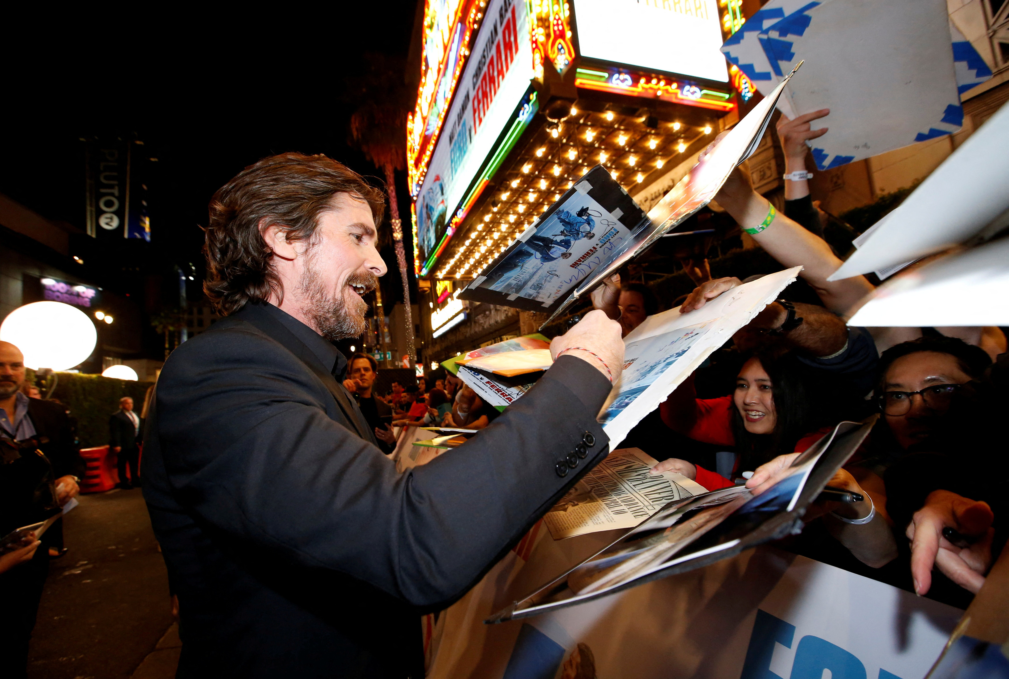 Cast member Bale signs autographs at a special screening for the movie 