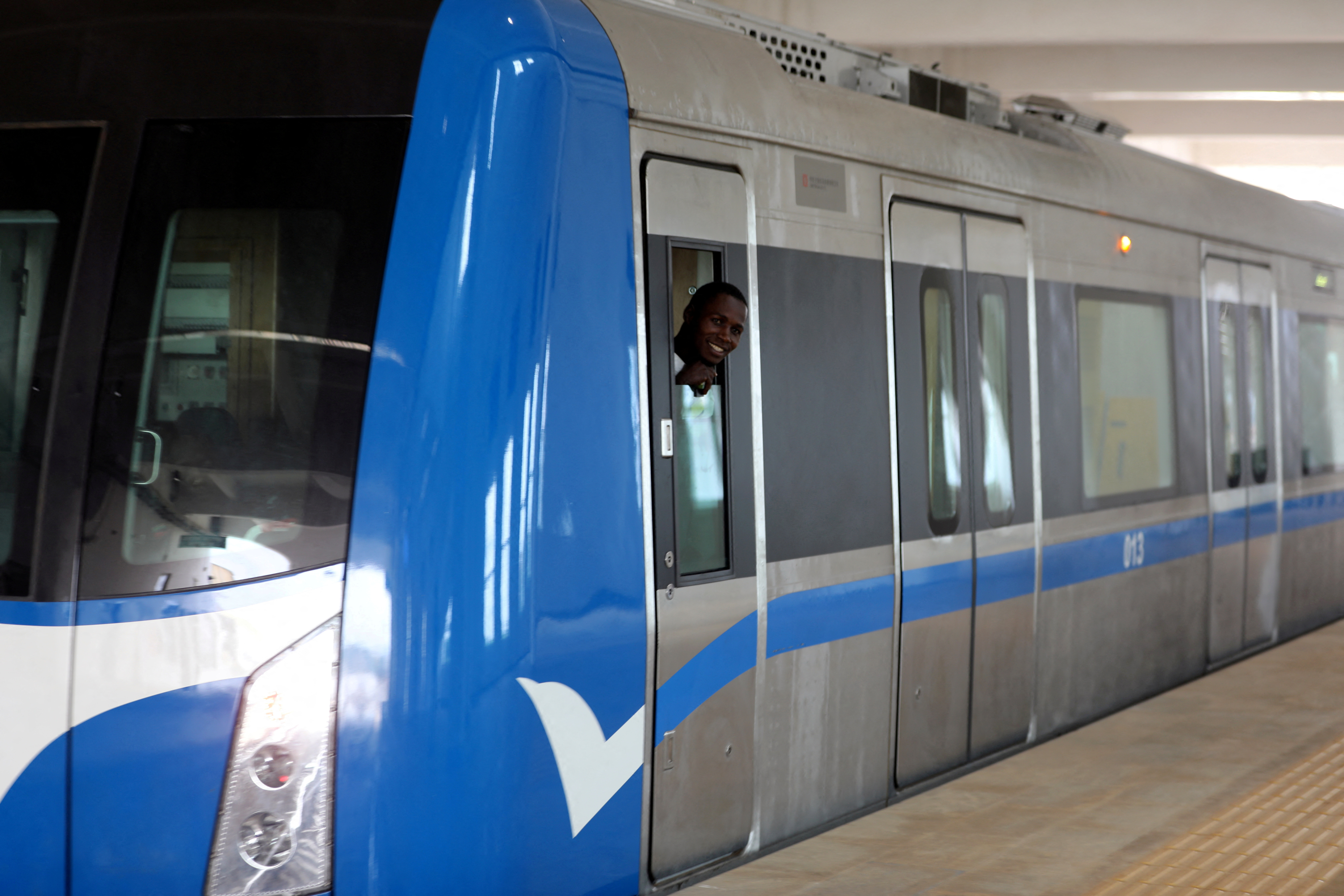 A passenger smiles as he looks out of the newly commissioned Abuja light rail train at the station In Abuja