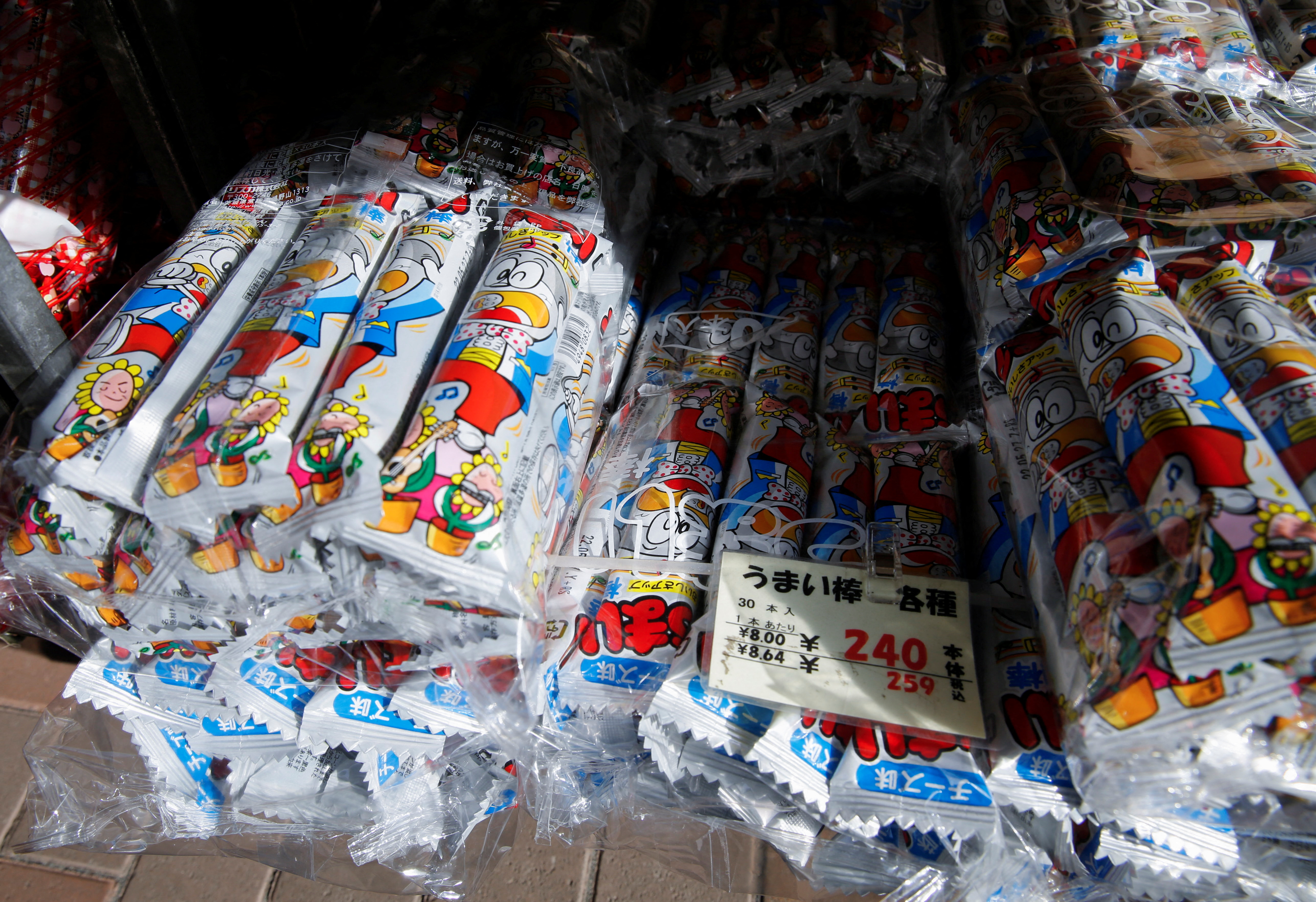 Packs of cheese flavoured version of 'Umaibo', a popular Japanese corn snack, are displayed at a confectionery wholesaler's in Tokyo