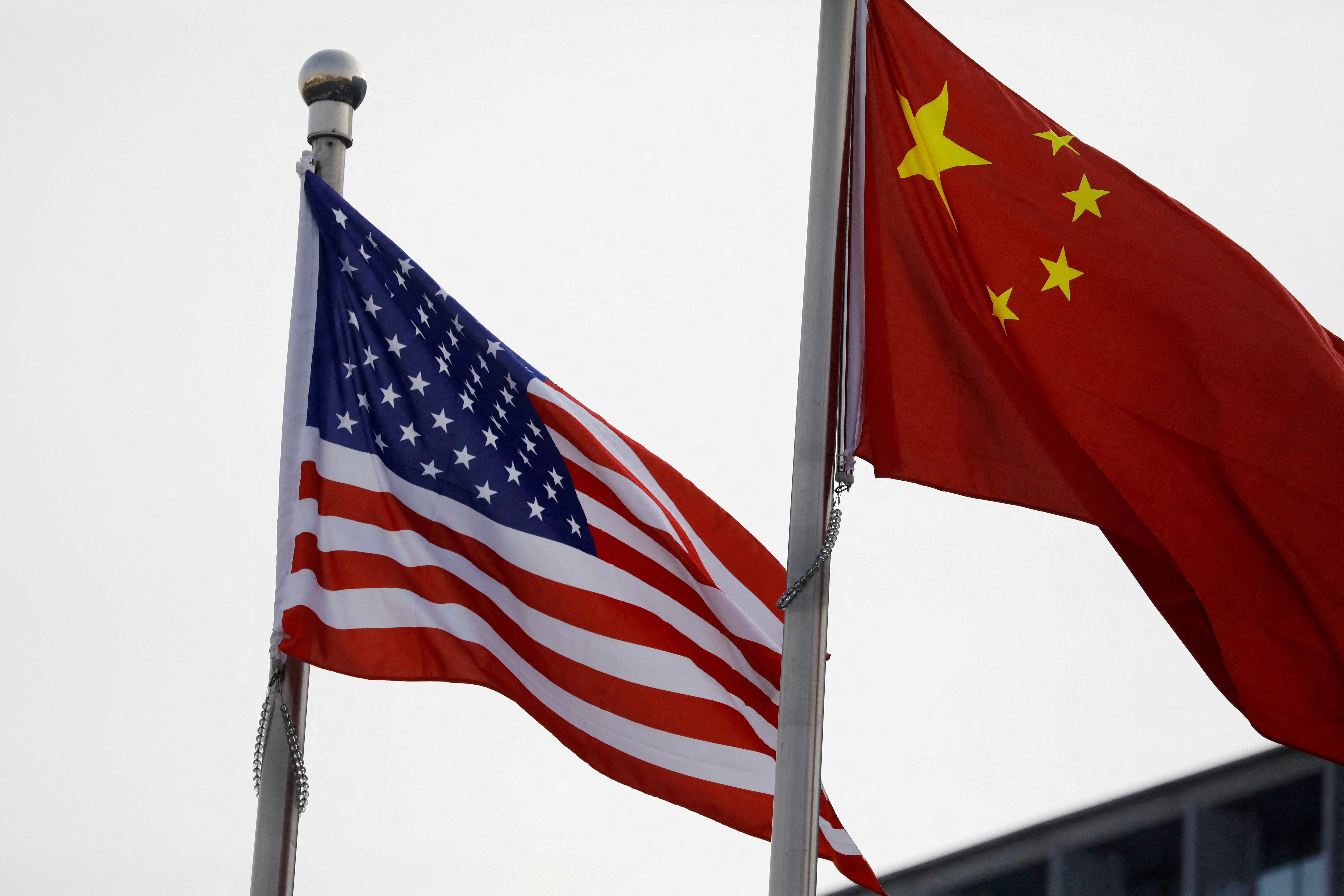 Chinese and U.S. flags flutter outside the building of an American company in Beijing