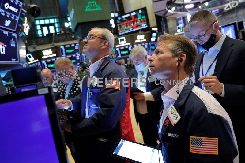 Traders works at the New York Stock Exchange (NYSE) in Manhattan, New York City