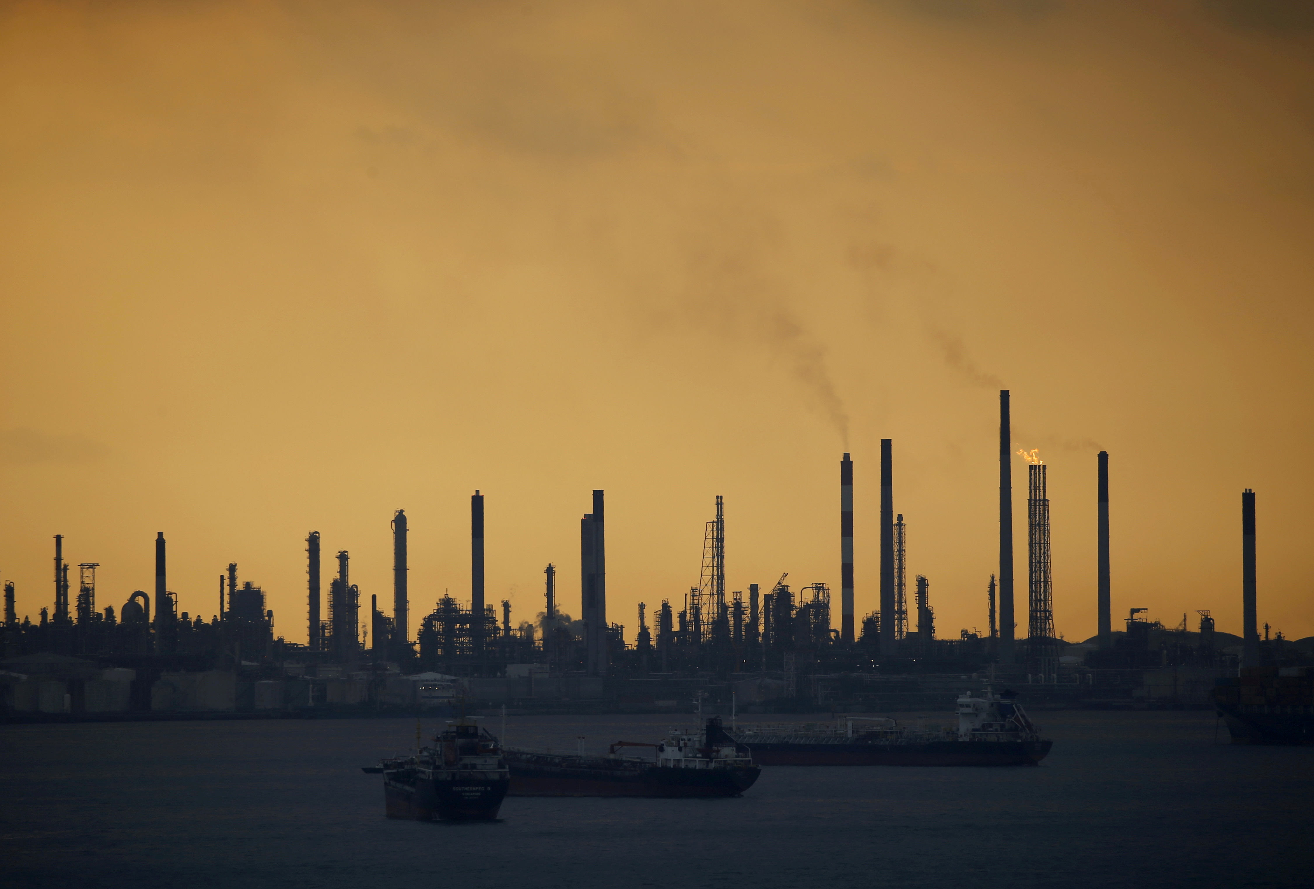 Storm clouds gather over Shell's Pulau Bukom oil refinery in Singapore