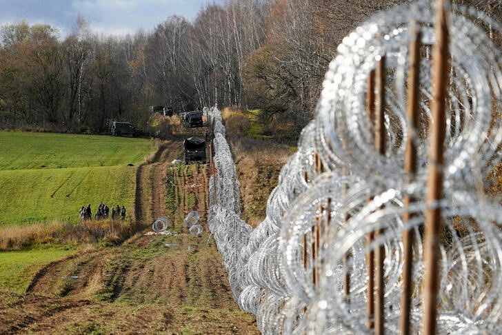 Soldiers build razor wire fence on Poland's border with Russia's exclave of Kaliningrad near Bolcie