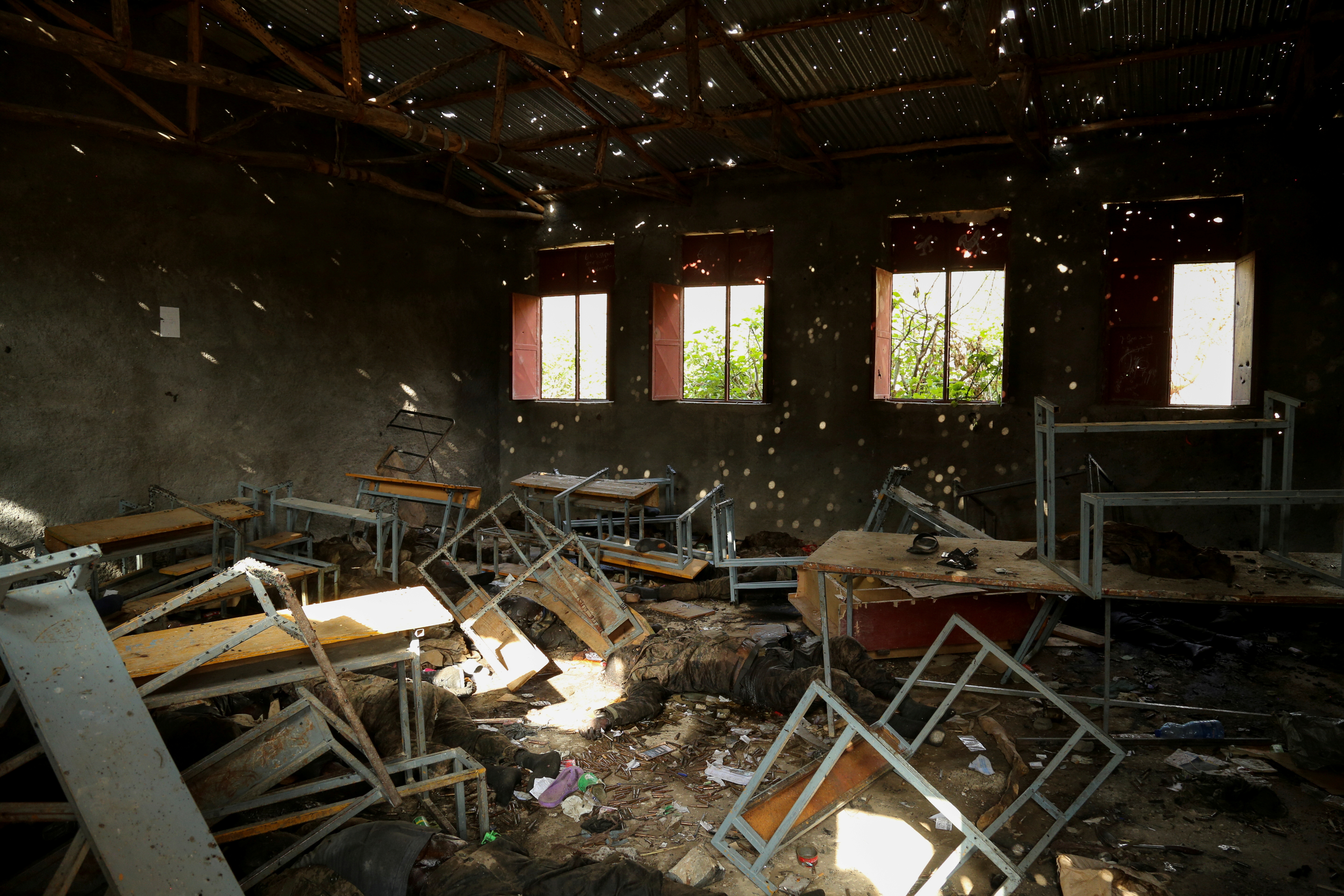  Light filters through the bullet-ridden roof of a classroom where the bodies of at least 27 dead soldiers from Ethiopia's military are lying in the village of Sheweate Hugum in south-central Tigray, Ethiopia, July 10, 2021. REUTERS/Giulia Paravicini/File Photo