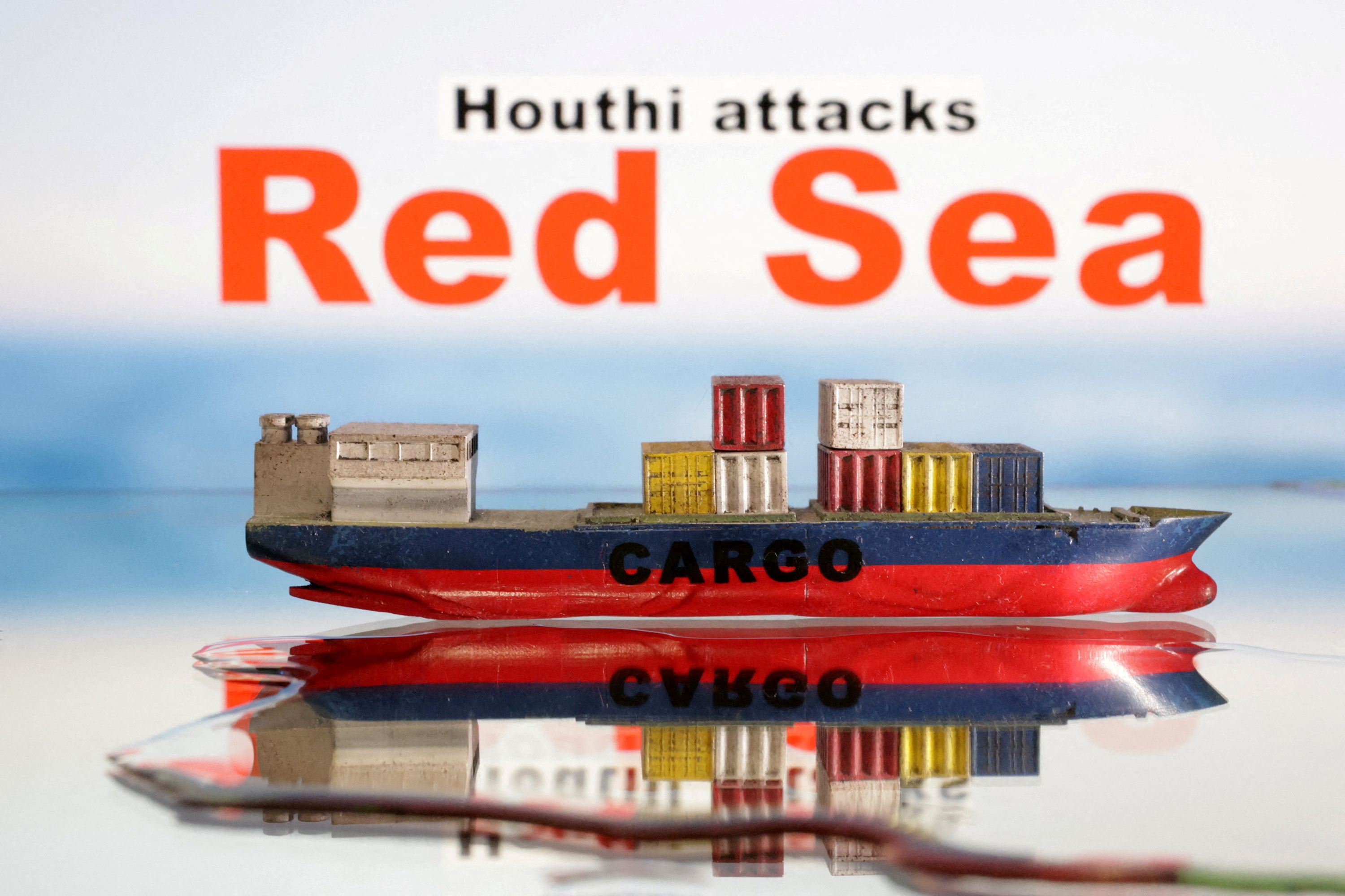 Illustration shows a cargo ship boat model and "Red Sea" and "Houthi attacks" words