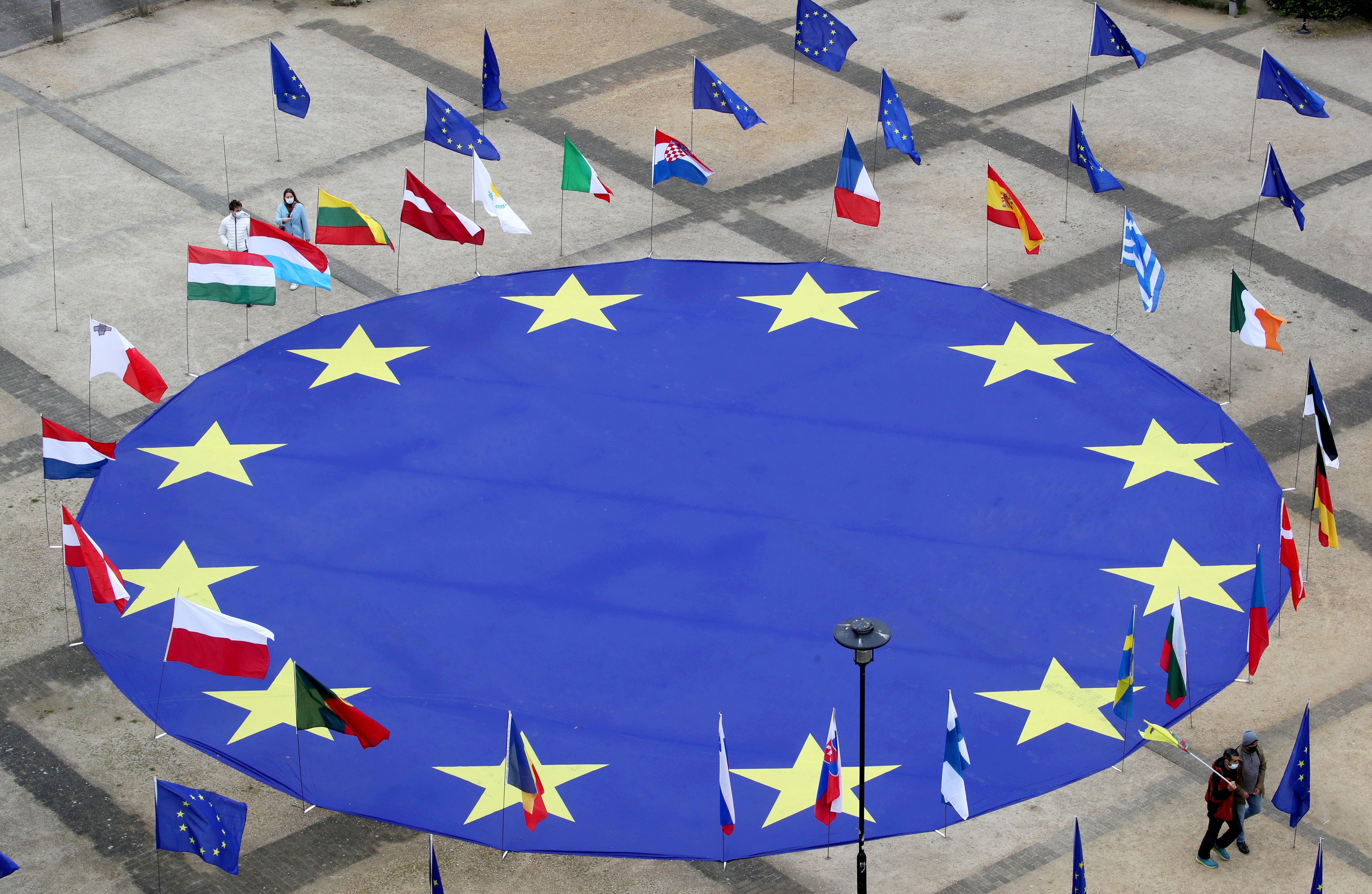 A large European Union flag lies at the centre of Schuman Square outside European Commission headquarters in Brussels, Belgium, May 8, 2021.  REUTERS/Yves Herman