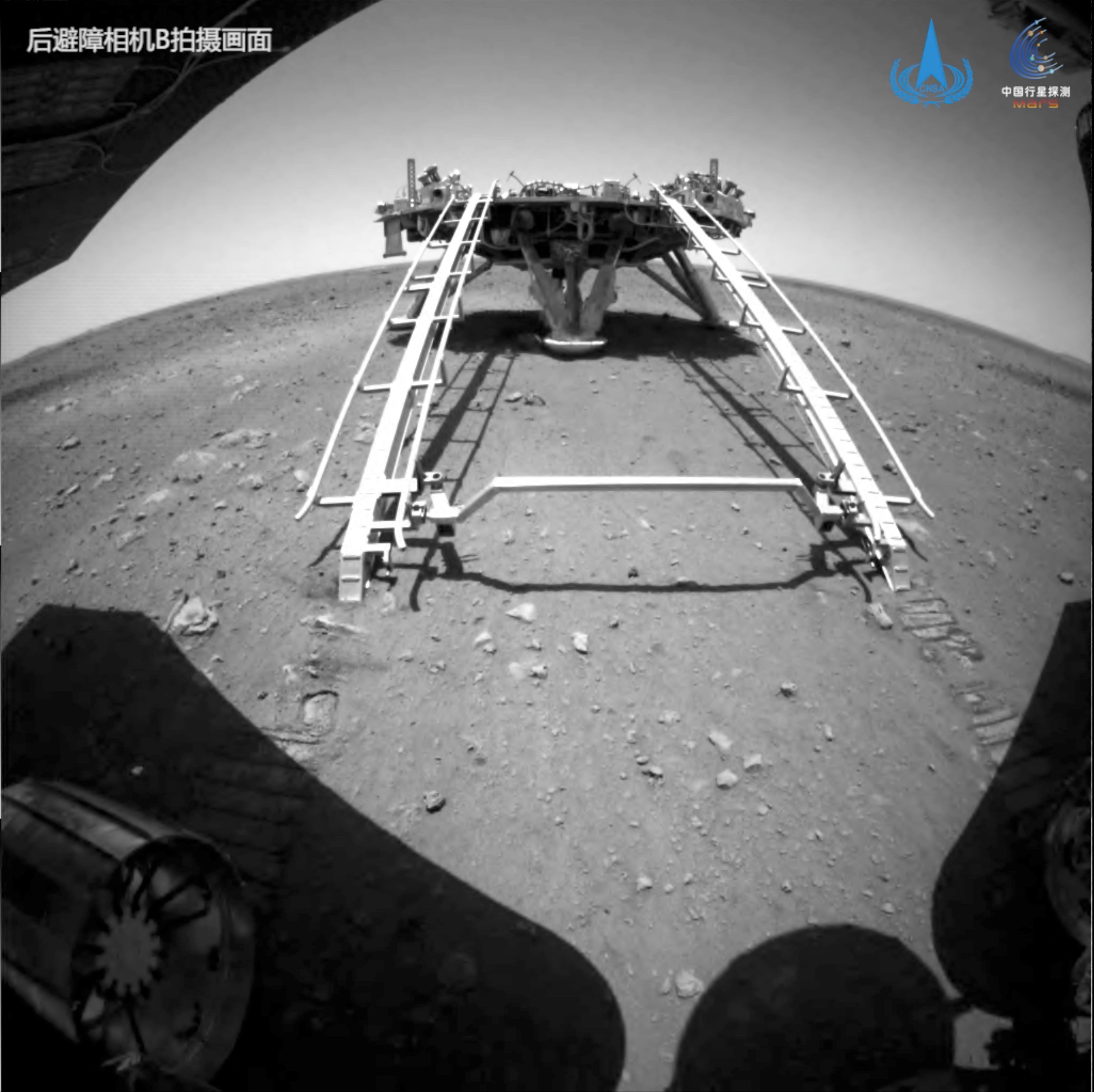 Handout image of Chinese rover Zhurong of the Tianwen-1 mission driving down the ramp of the lander onto the surface of Mars