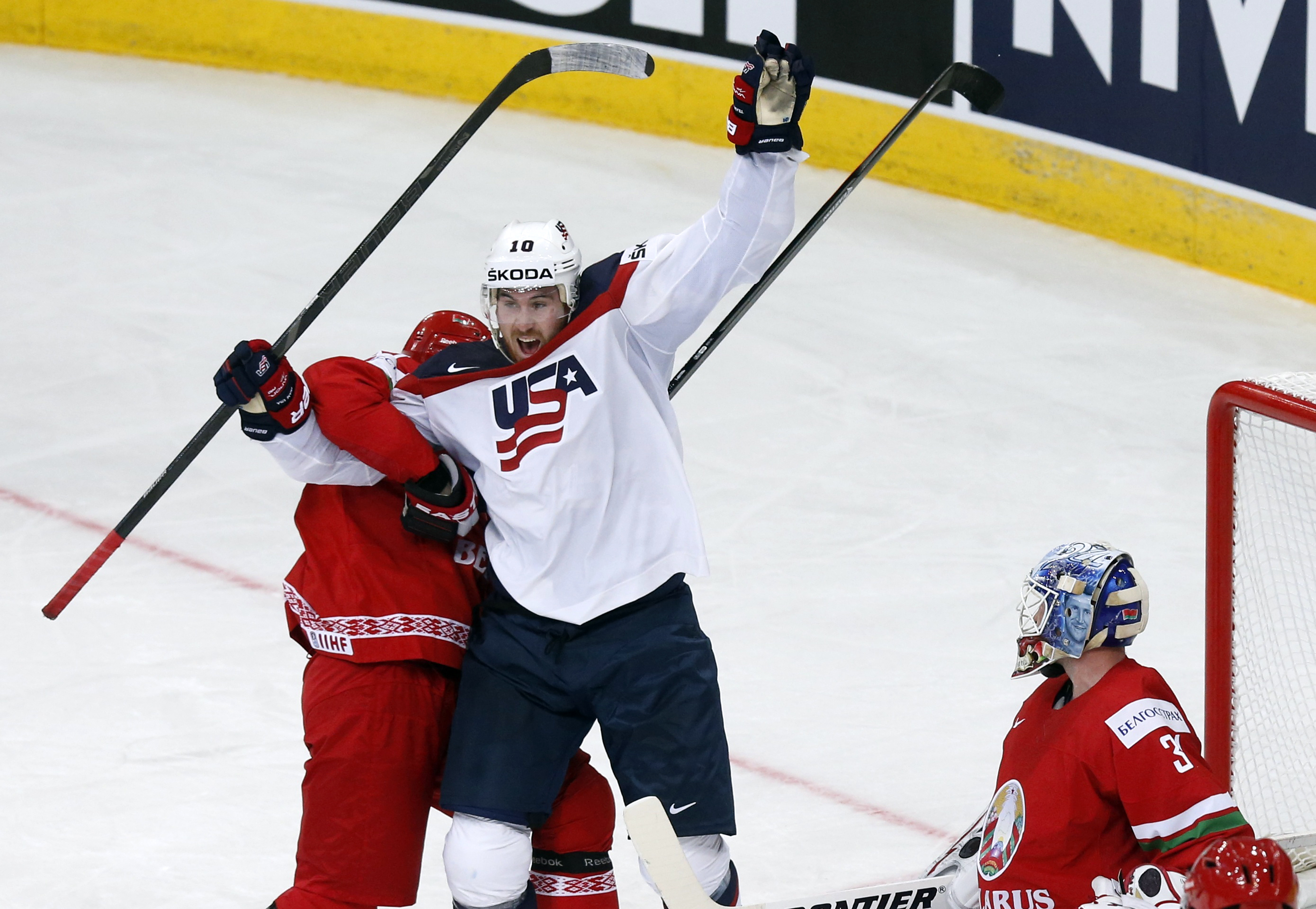 Hayes of the U.S. celebrates the goal of team mate Trouba against goalkeeper Mezin of Belarus during the second period of their men's ice hockey World Championship Group B game at Minsk Arena in Minsk