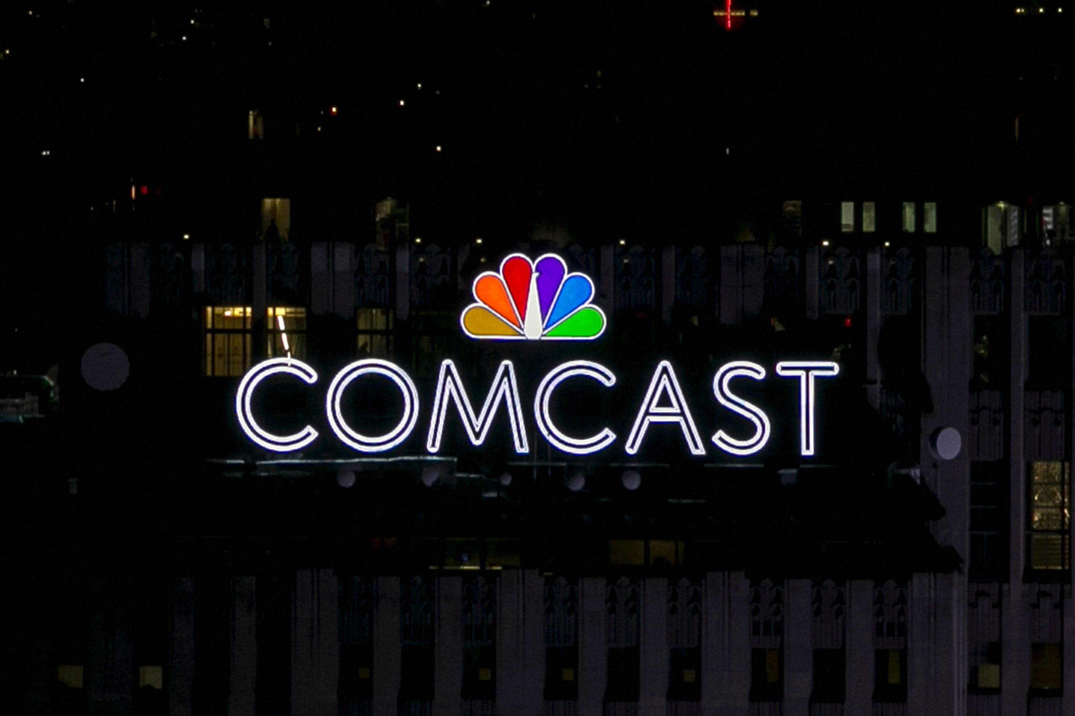 The NBC and Comcast logo are displayed on top of 30 Rockefeller Plaza, formerly known as the GE building, in midtown Manhattan in New York