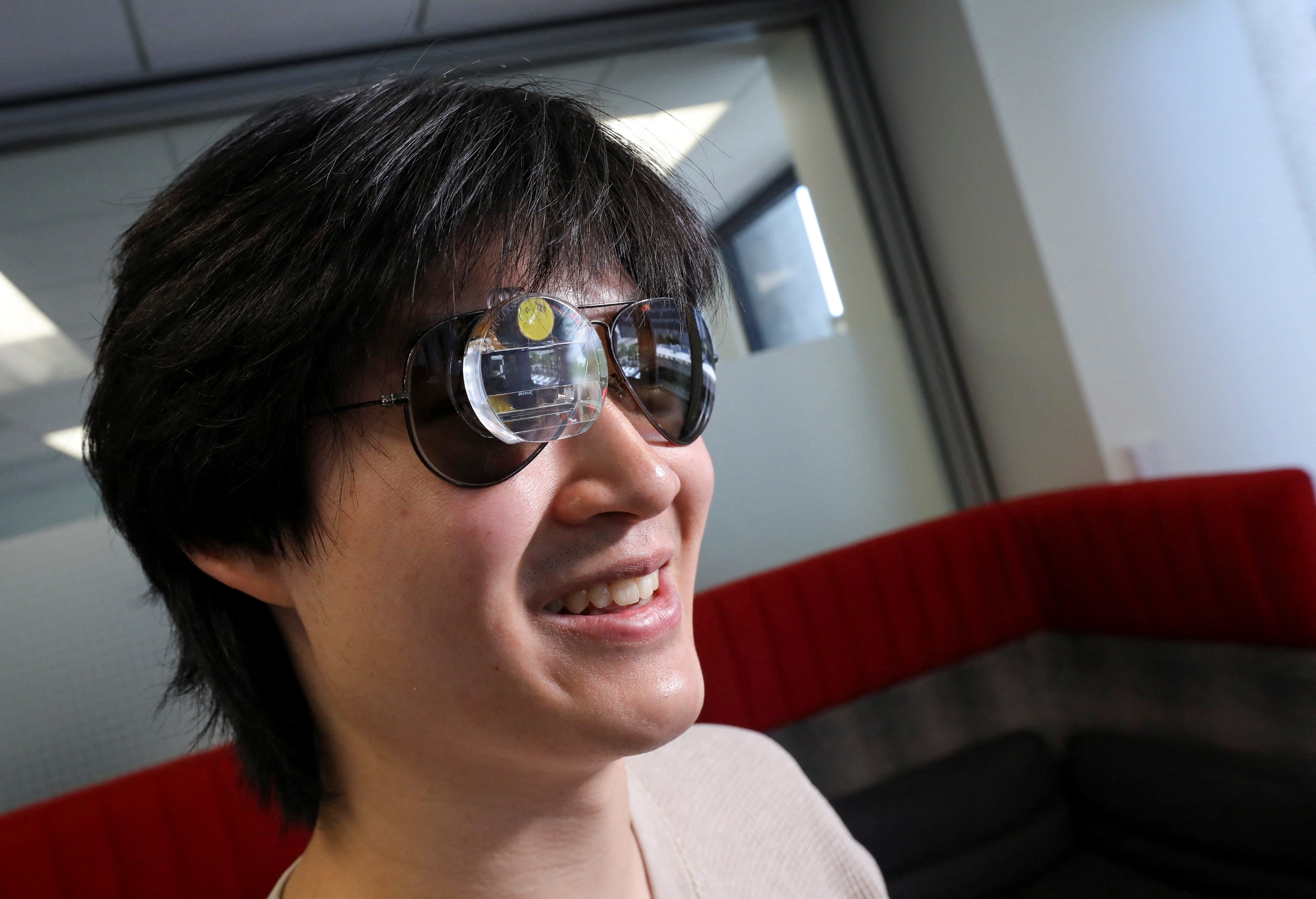 Bryan Chiang wears an augmented reality eyepiece equipped with RizzGPT in San Francisco, California