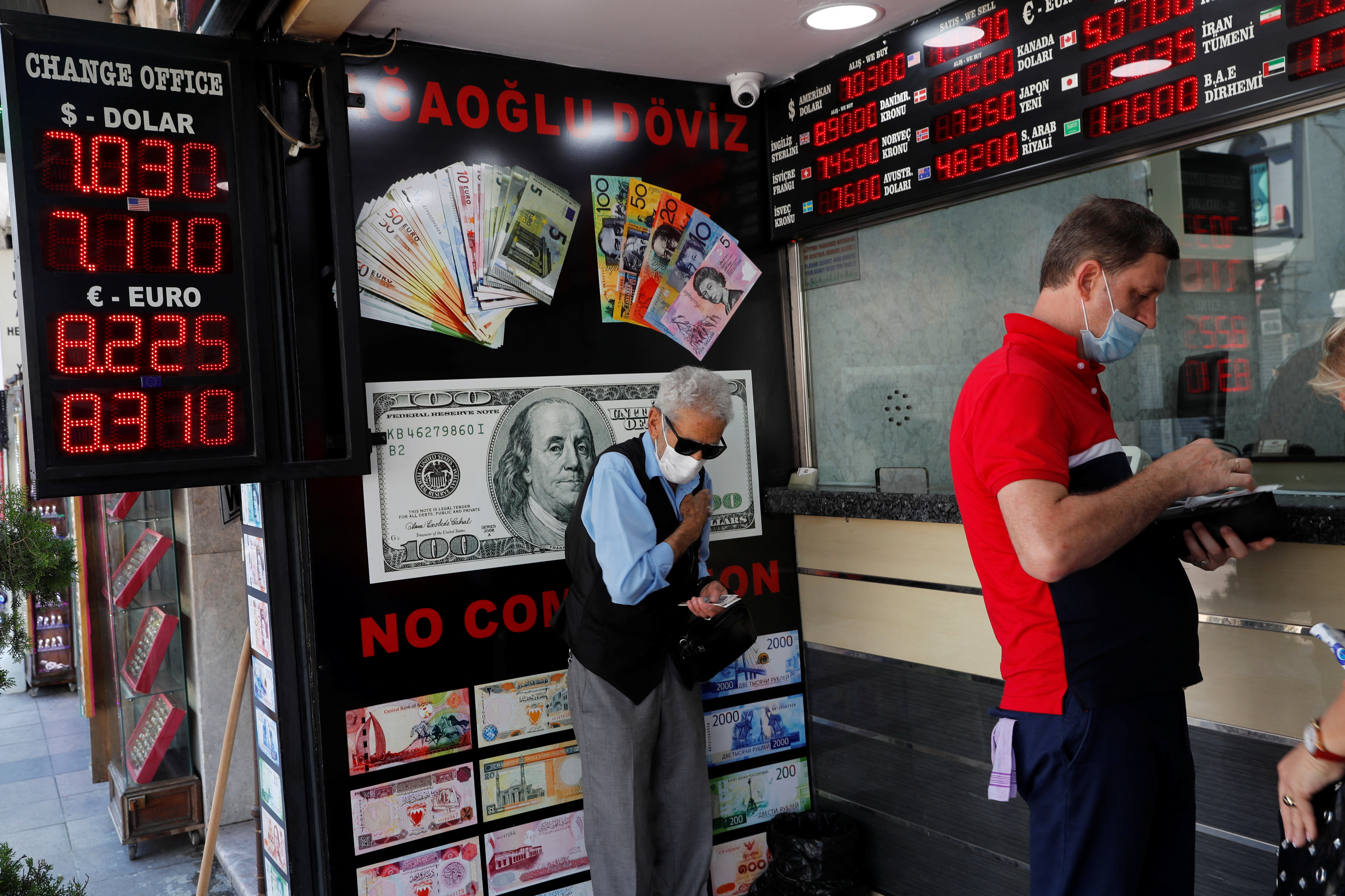 People change money at a currency exchange office in Istanbul