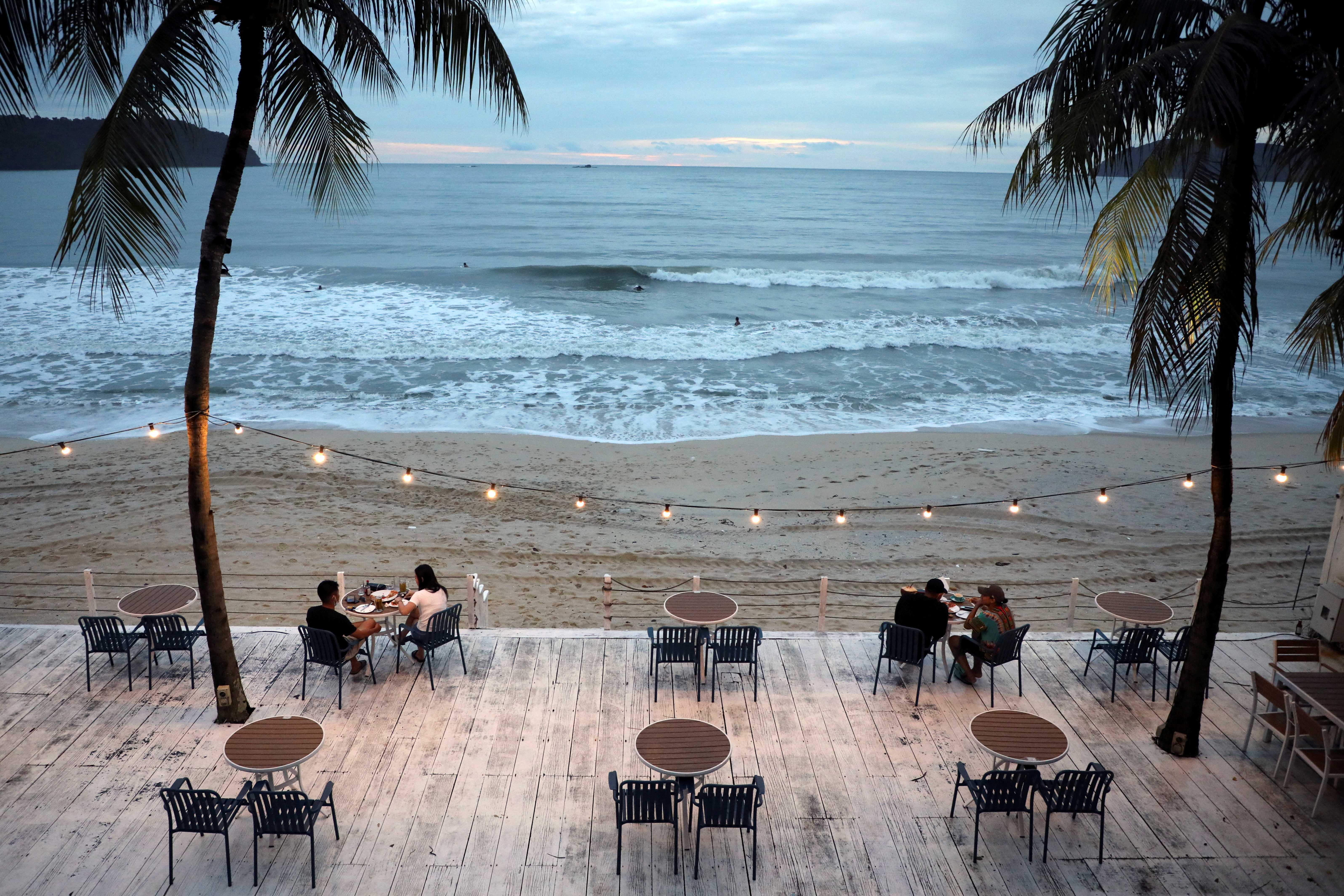 People dine-in at a restaurant following social distancing measures in Langkawi