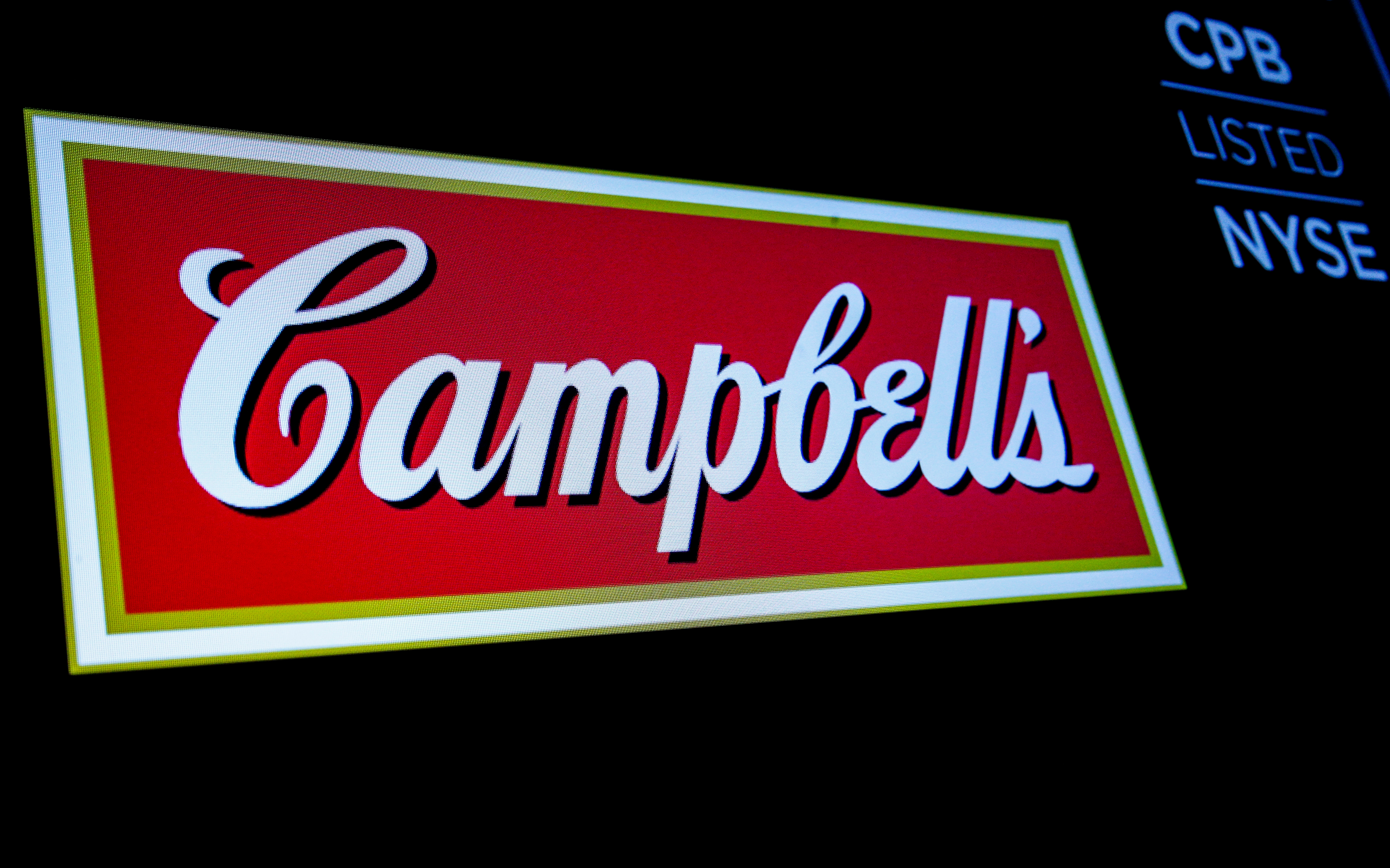 The logo and ticker for Campbell Soup Co. are displayed on a screen on the floor of the NYSE in New York