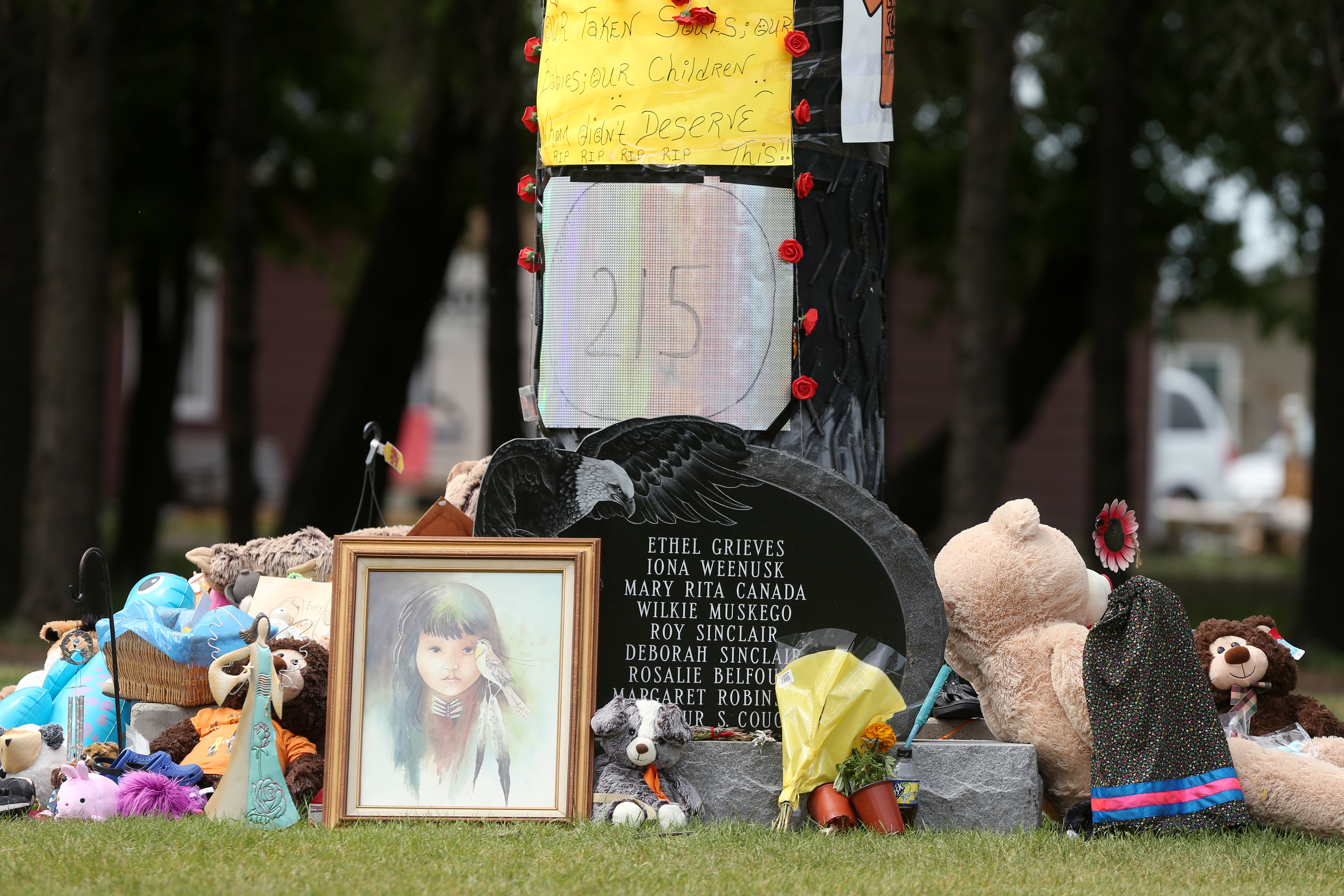 Children's shoes, toys, candy, tobacco and flowers are left on a memorial at the Portage La Prairie Indian Residential School, which closed in 1975, in Portage La Prairie, Manitoba, Canada June 8, 2021.  REUTERS/Shannon VanRaes