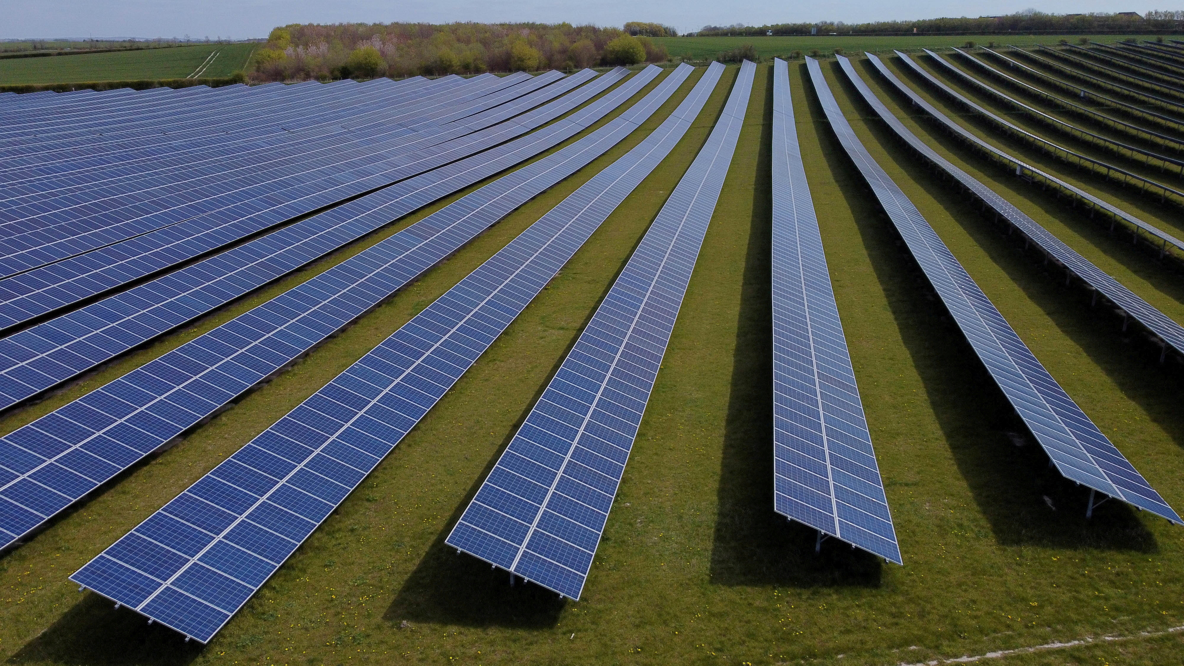 A field of solar panels is seen near Royston, Britain, April 26, 2021. Picture taken with a drone. REUTERS/Matthew Childs