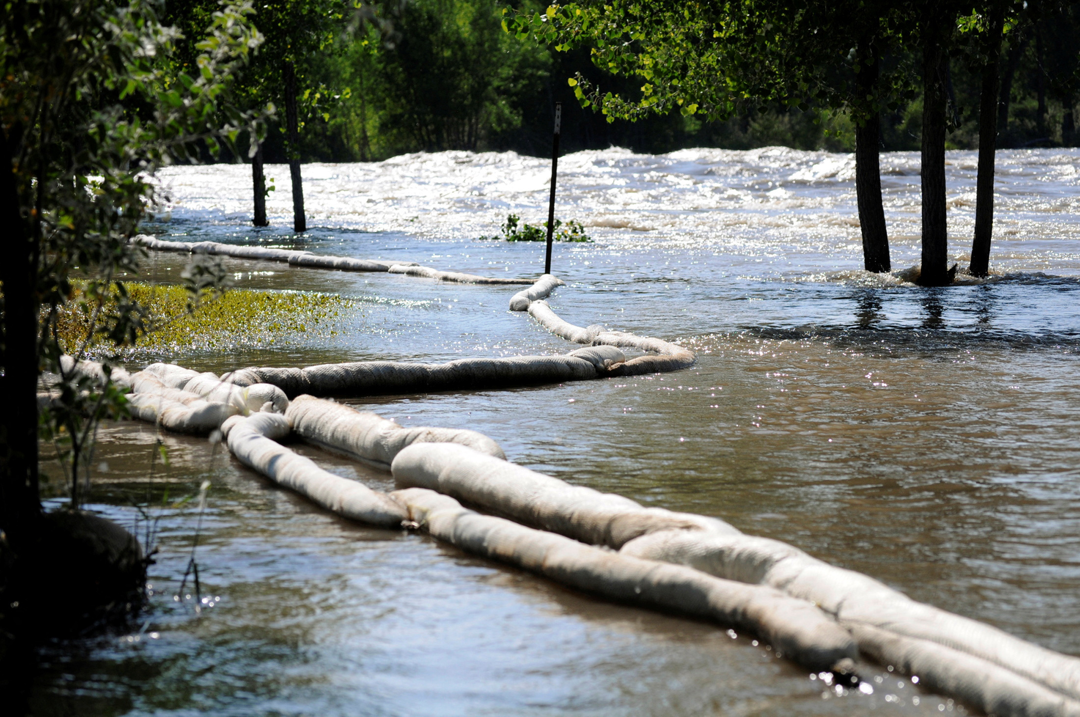 Absorbent boom is placed after an oil spill along the Yellowstone River in Laurel Montana