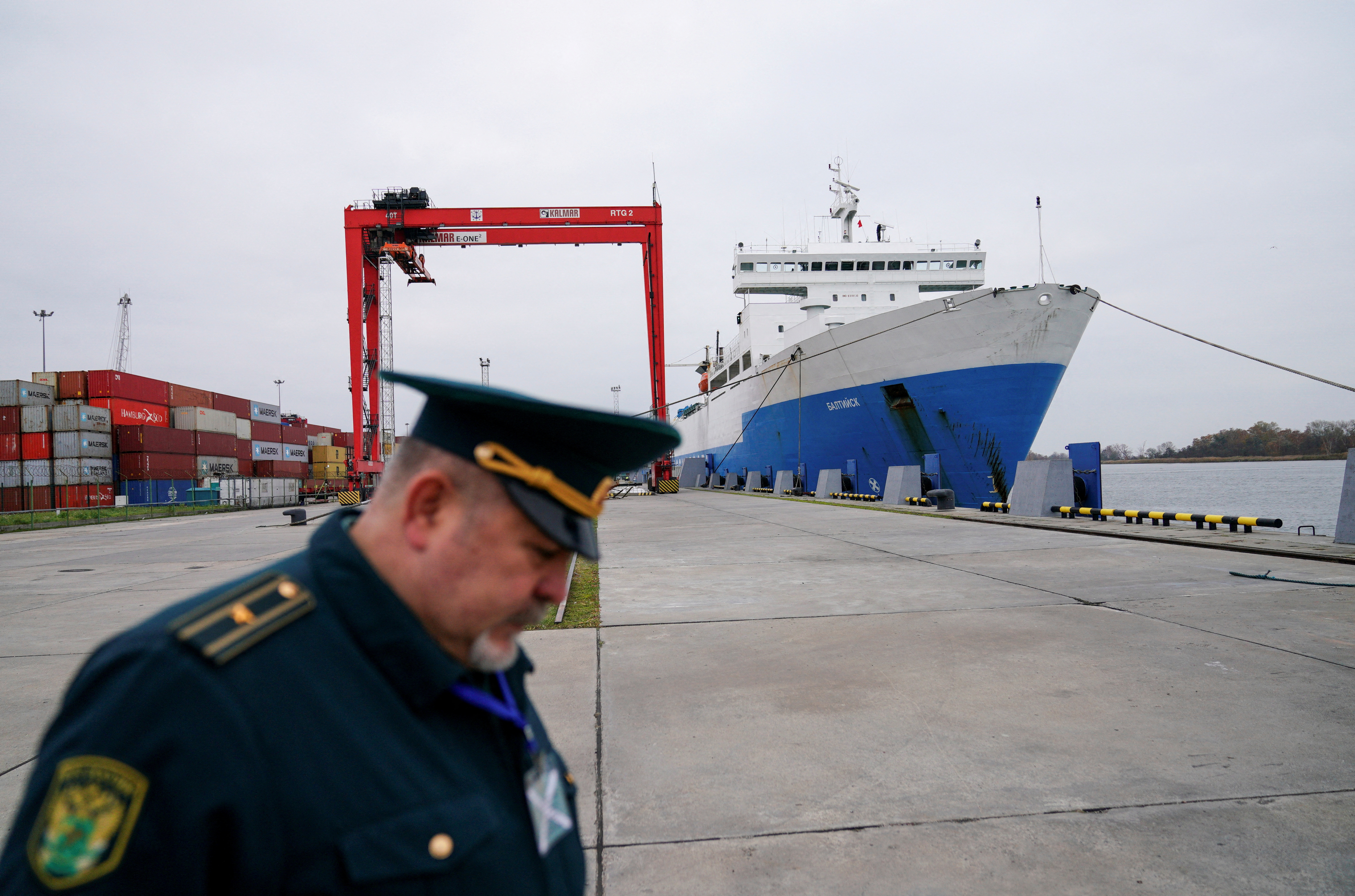 A Russian customs officer works at a commercial port in Baltiysk
