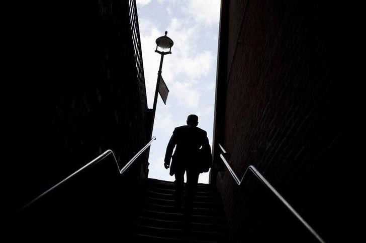 A man climbs a stairway in a narrow alley in Temple Bar