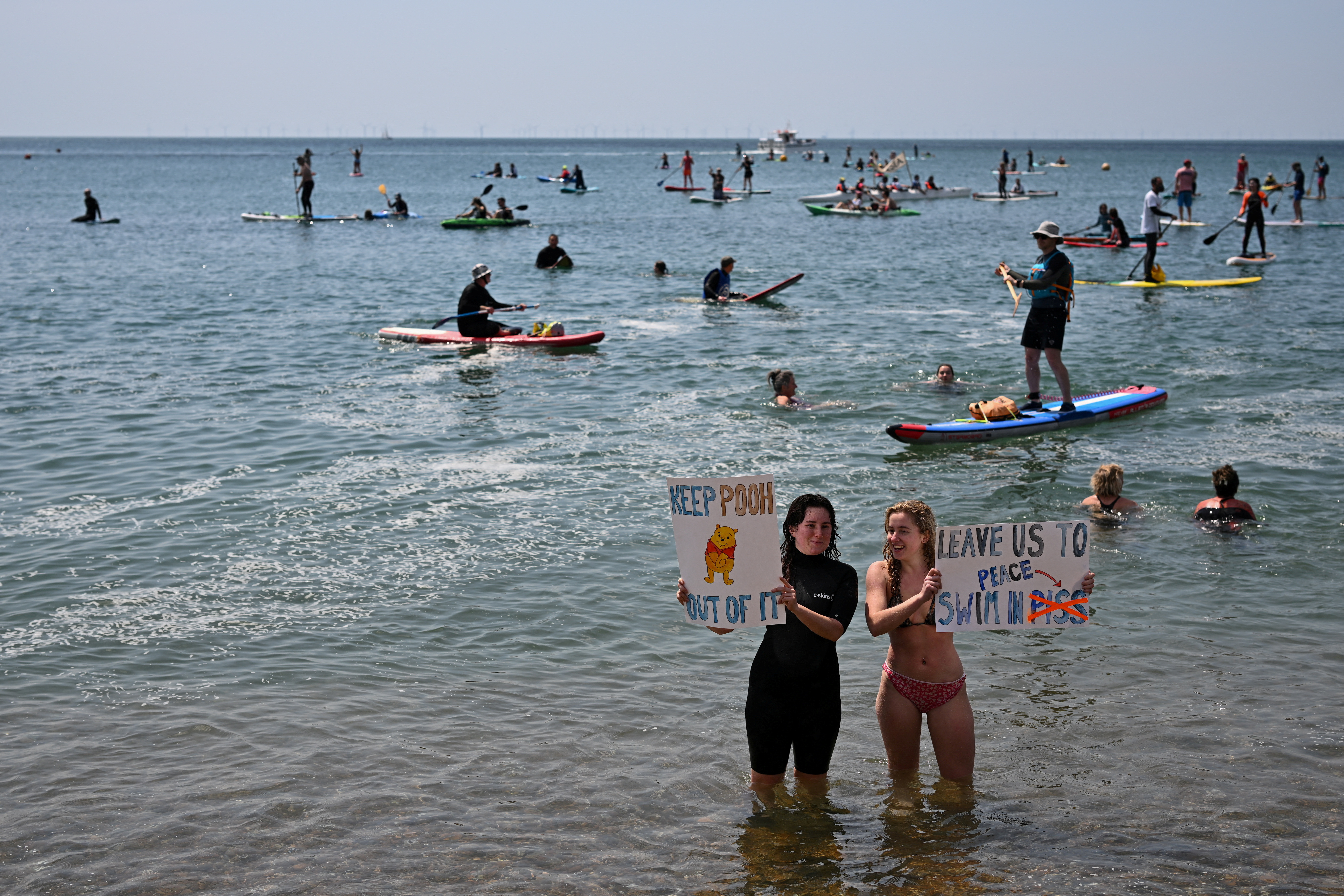 Surfers take part in a mass protest against the continued dumping of untreated sewage by water companies, in Brighton