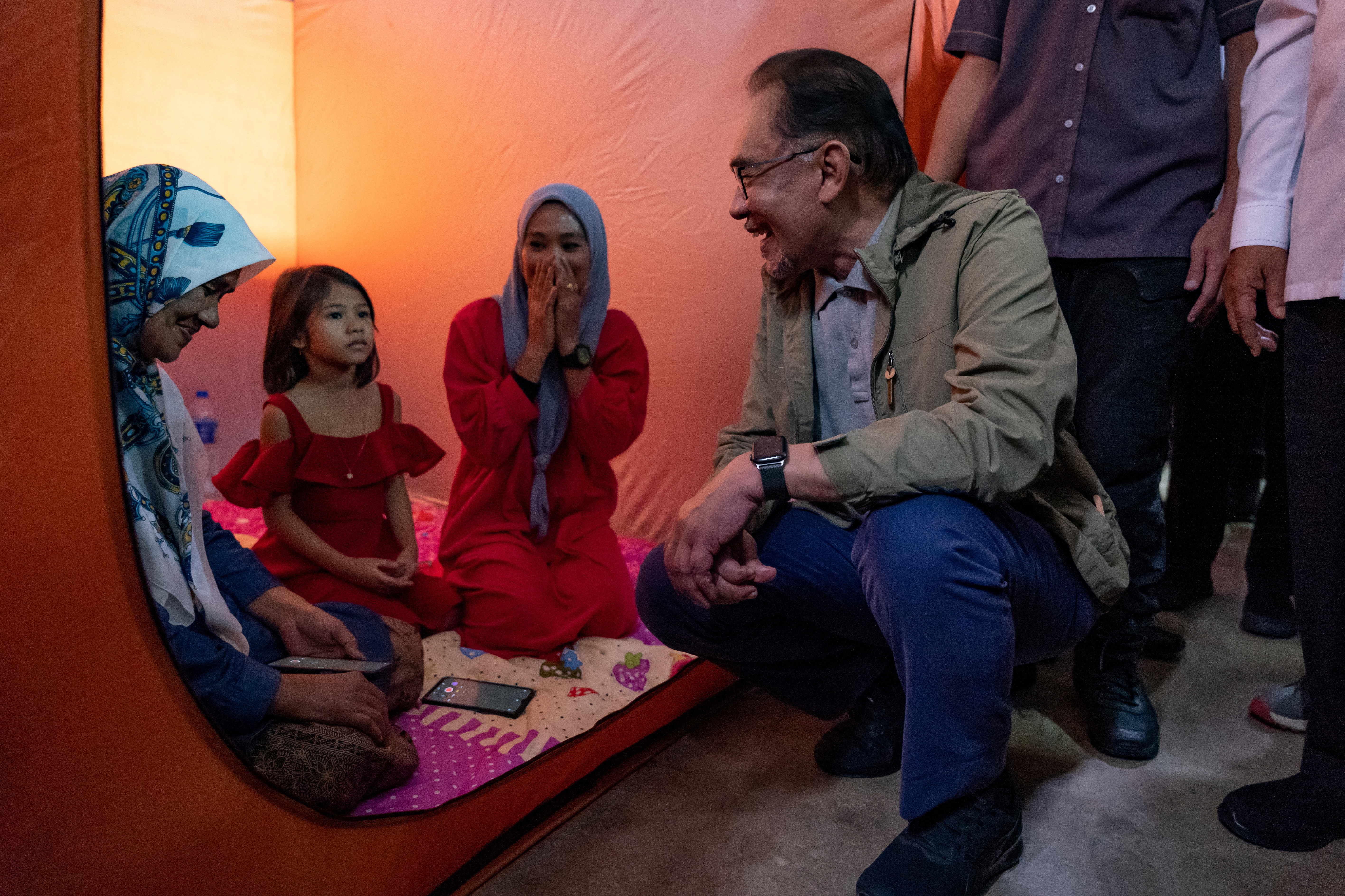 Malaysia's Prime Minister Anwar Ibrahim meets flood victims at a relief centre in Pasir Mas