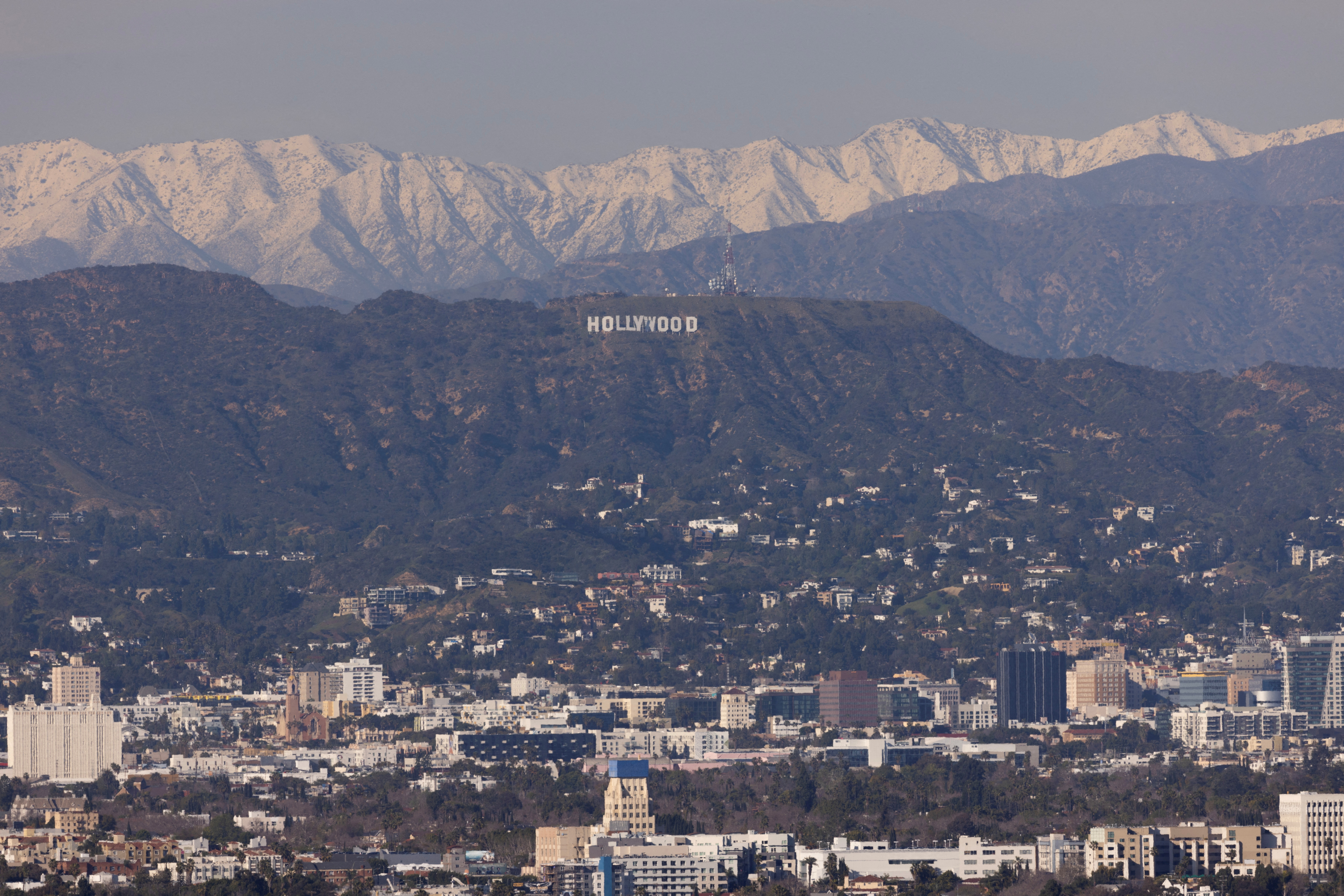 Snow-covered mountains surround the Hollywood sign in city of Los Angeles