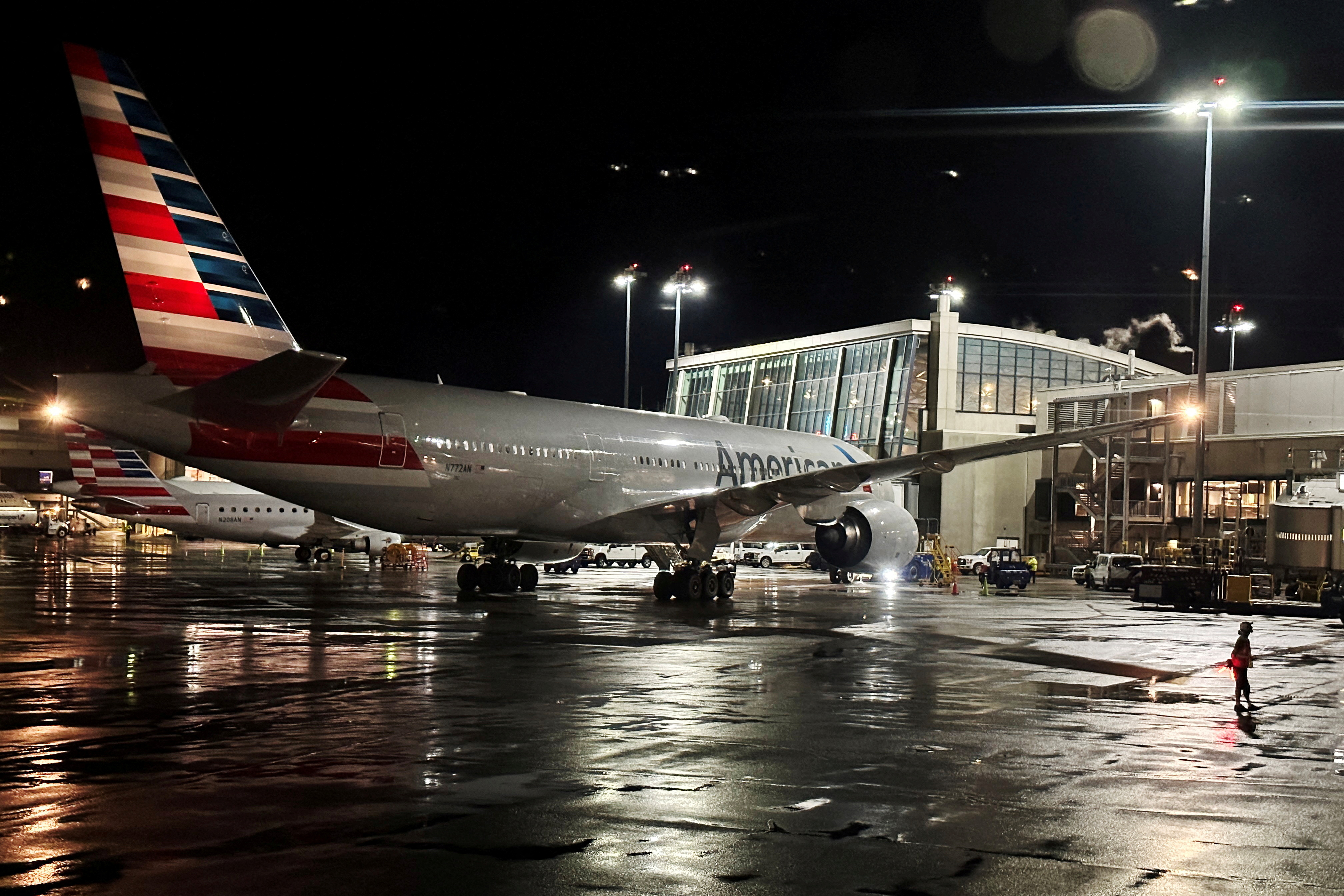 An American Airlines plane sits at a gate at Logan Airport ahead of the July 4th holiday in Boston