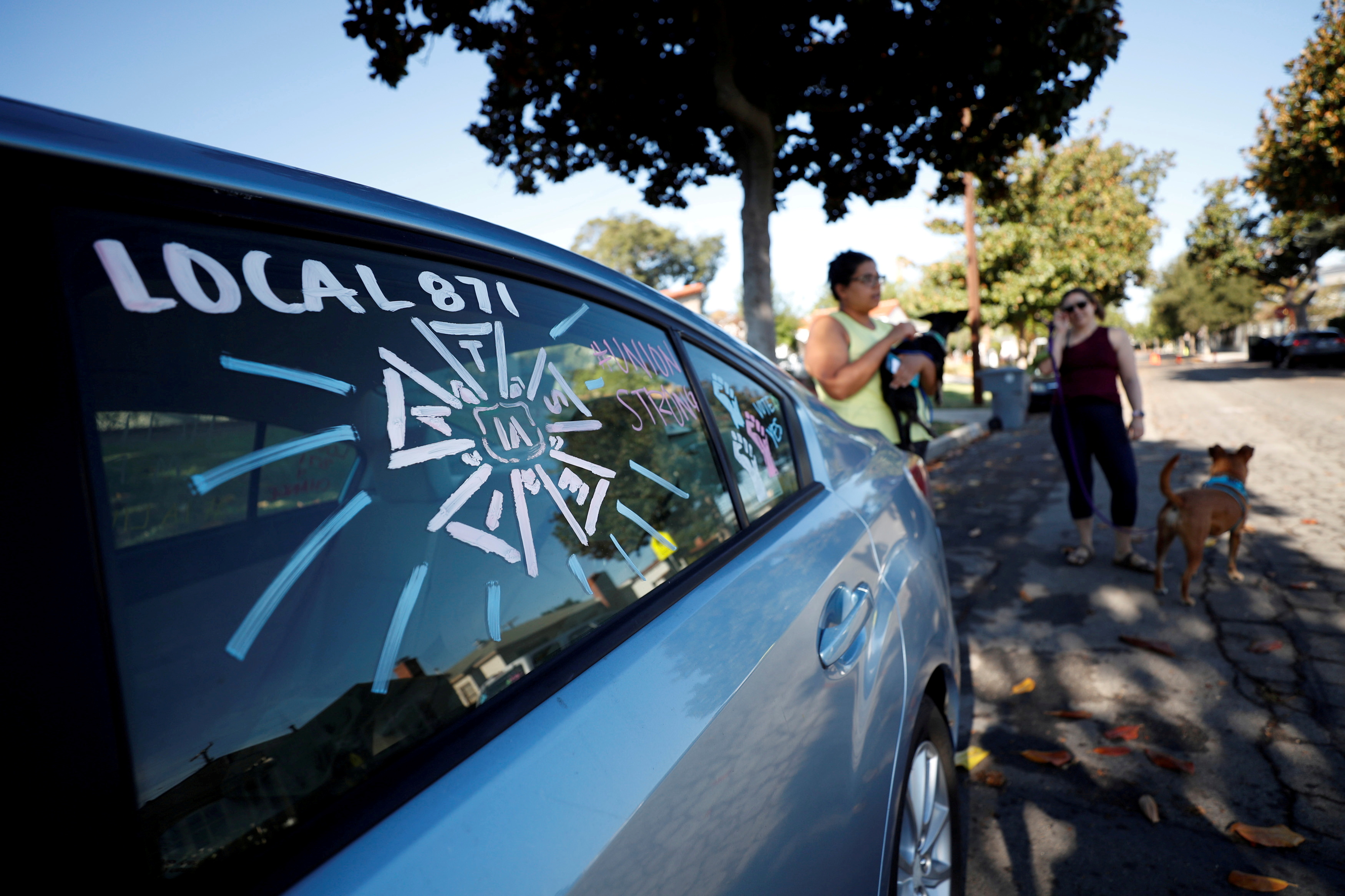 The adorned windows of the car belonging to script coordinator Amy Thurlow, a member of the International Alliance of Theatrical Stage Employees (IATSE) Local 871 since 2018, are pictured the day after 90% of its members cast ballots and more than 98% of the votes returned were in favor of authorizing a strike in Glendale, California, U.S., October 5, 2021.  REUTERS/Mario Anzuoni