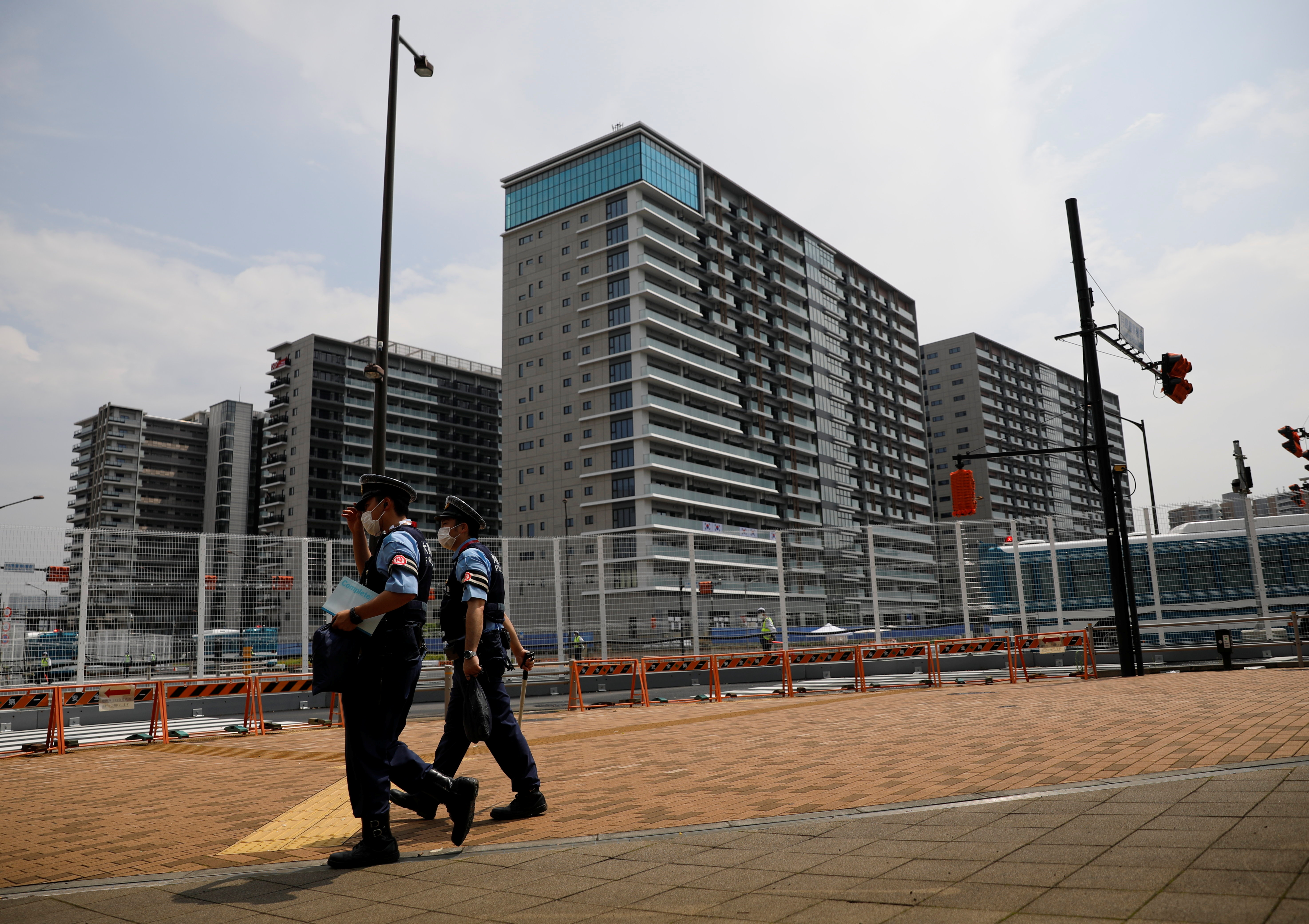 Police officers patrol outside the Athletes Village ahead of Tokyo 2020 Olympic Games in Tokyo
