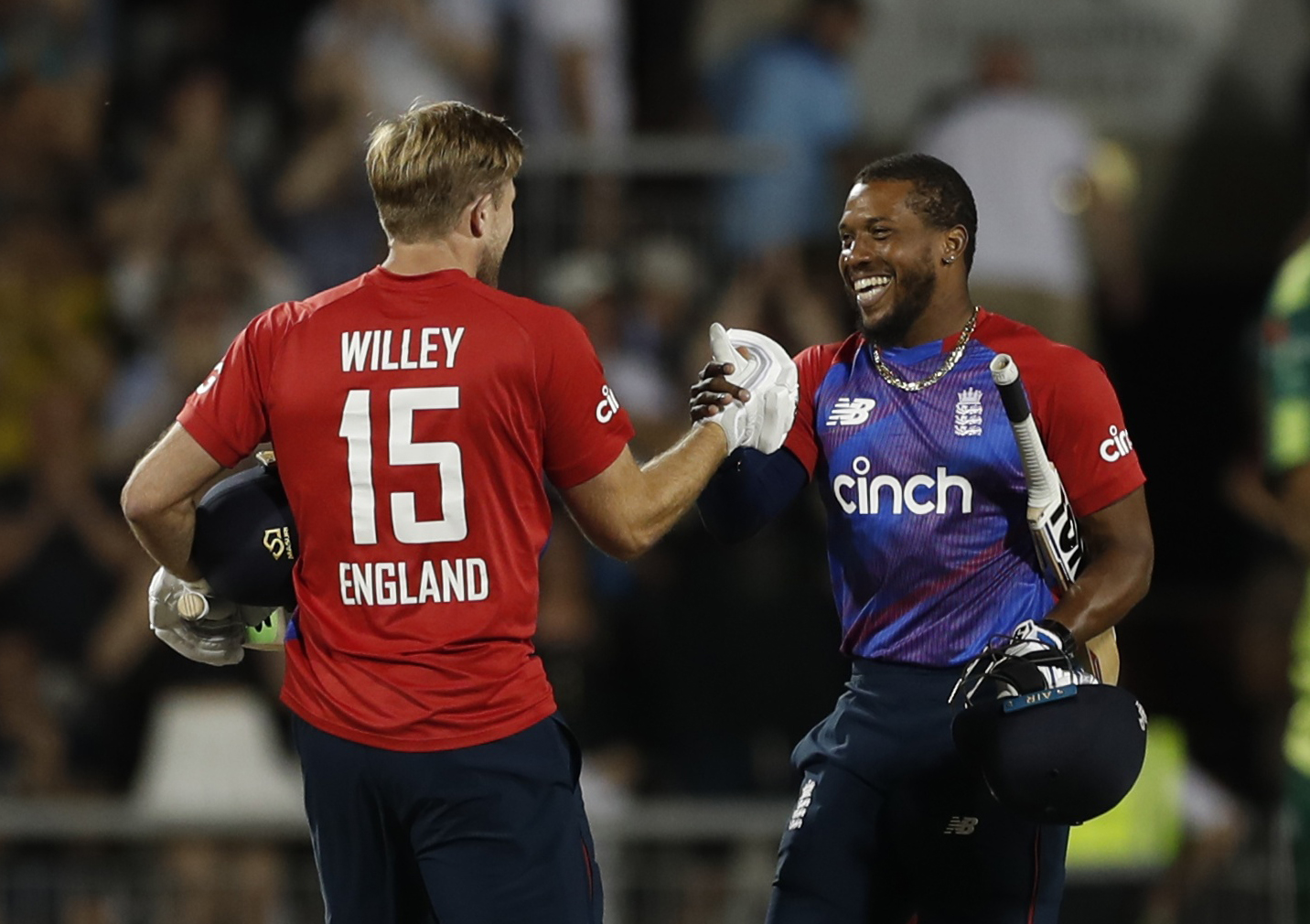 England's David Willey and Chris Jordan celebrate after winning the match Action: Photo via Reuters