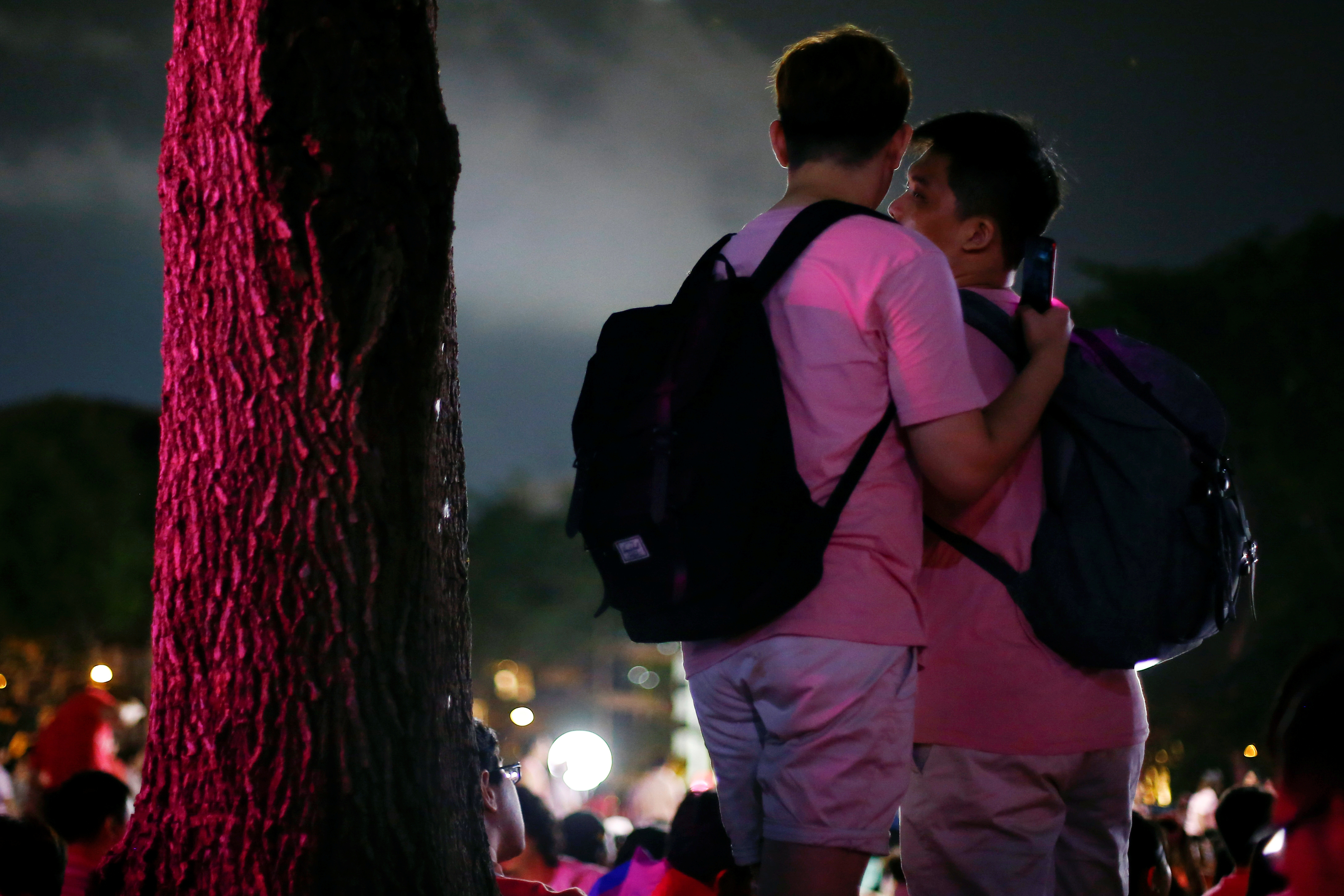 A couple attends Pink Dot, an annual event organised in support of the LGBT community at the Speakers' Corner in Hong Lim Park in Singapore