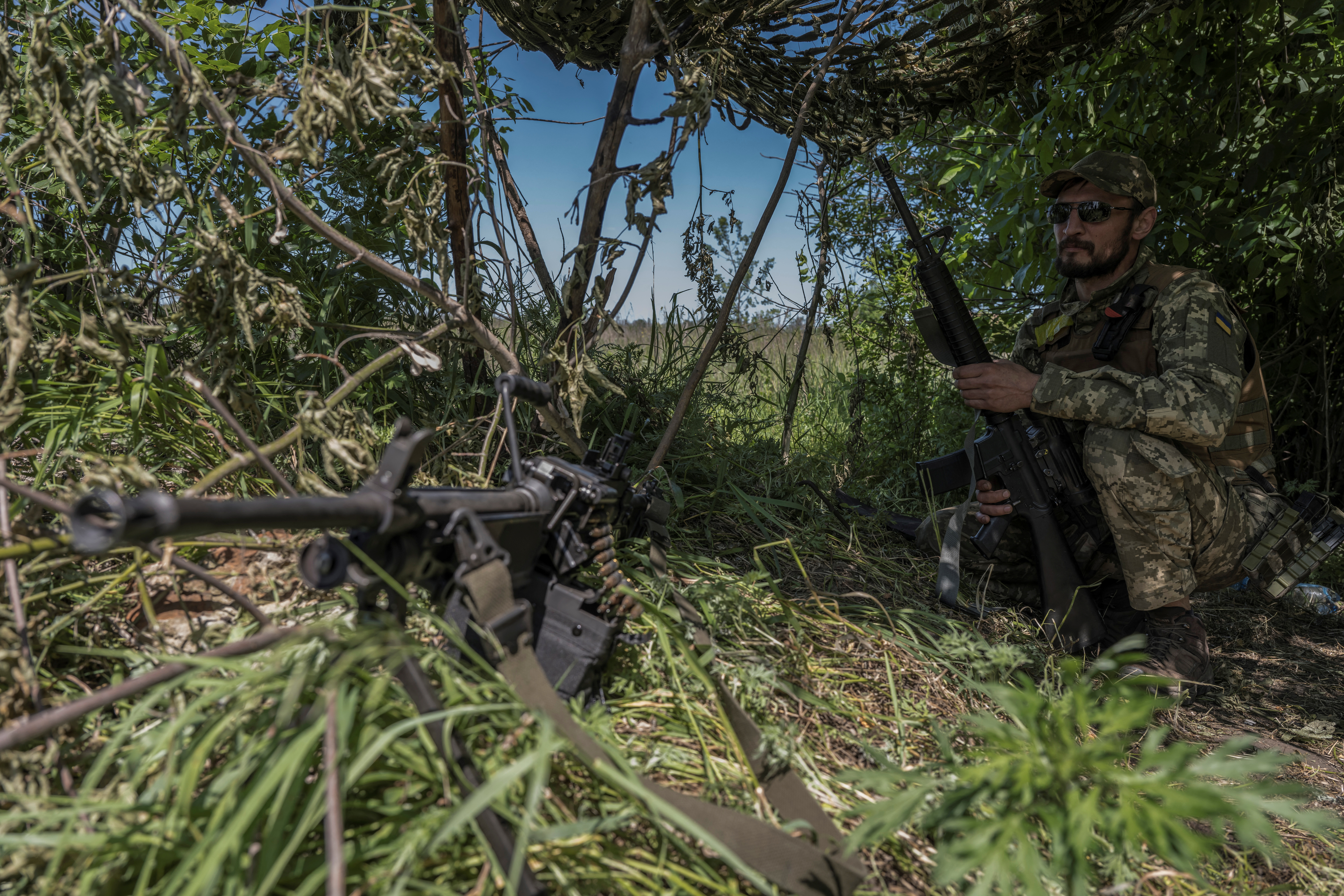 A Ukrainian serviceman looks on near the Ukraine-Russia border in Kharkiv region