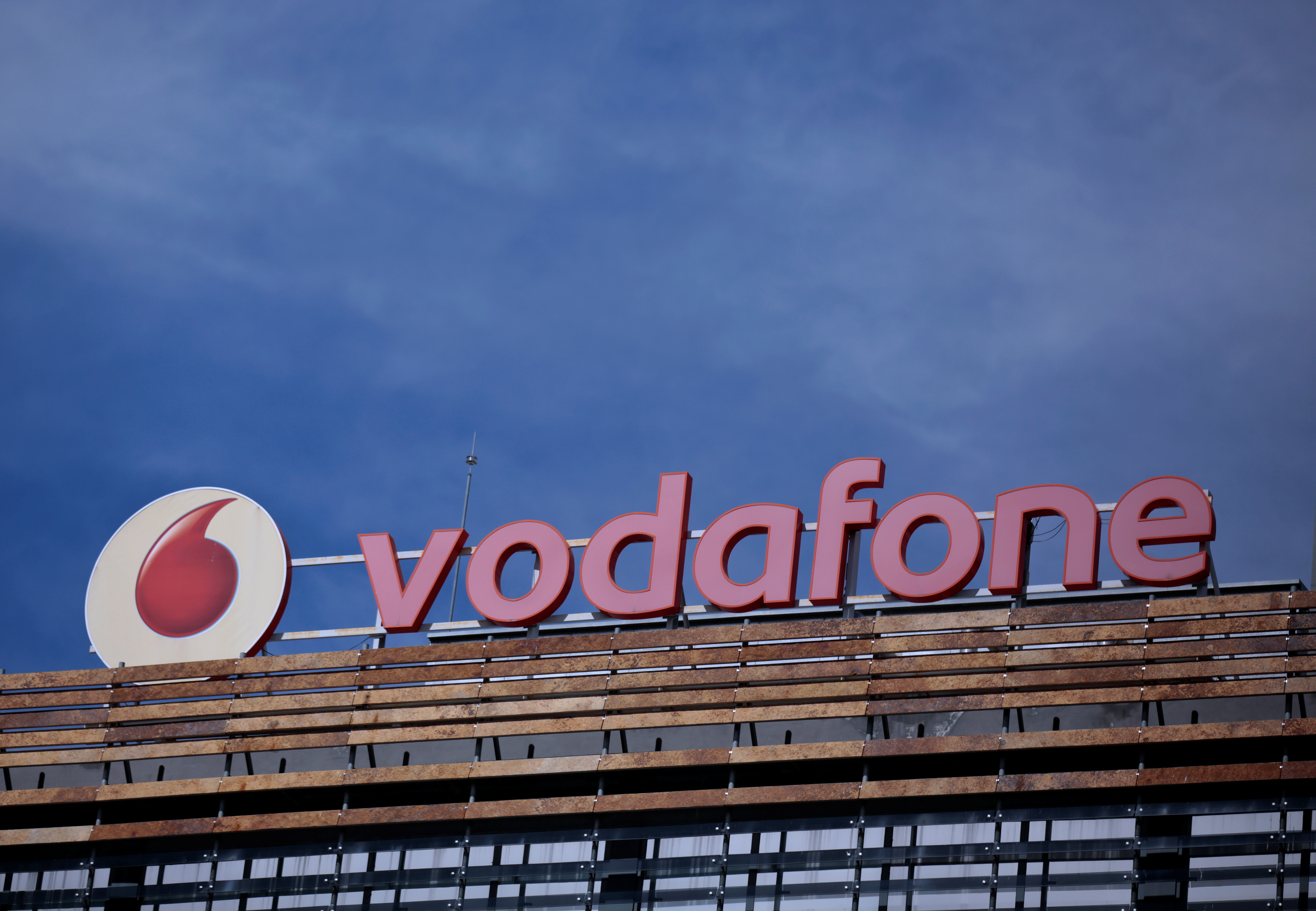 The Vodafone logo can be seen on top of a building outside Madrid, Spain