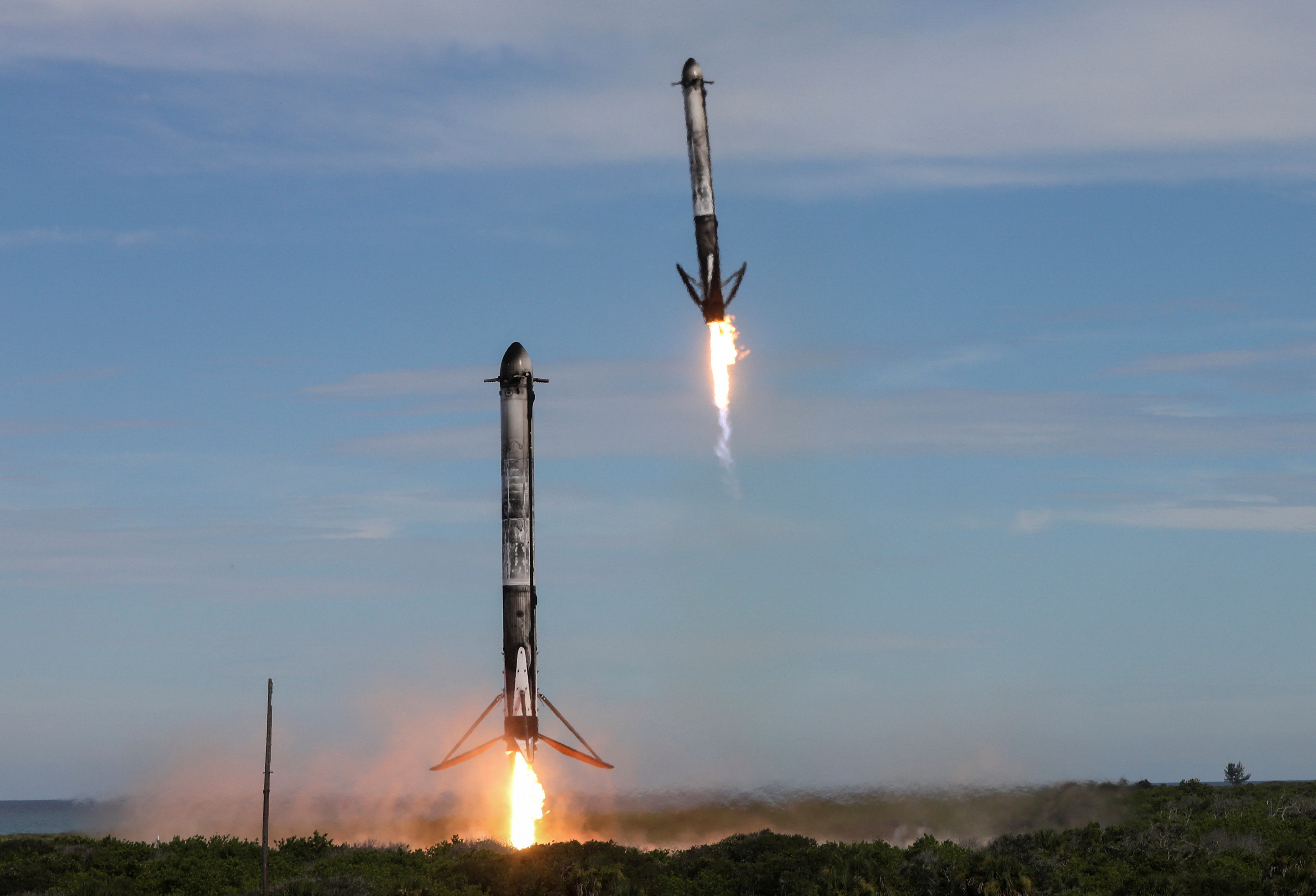 Two boosters return to the Cape Canaveral Space Force Station after launch from the nearby Kennedy Space Center in Cape Canaveral