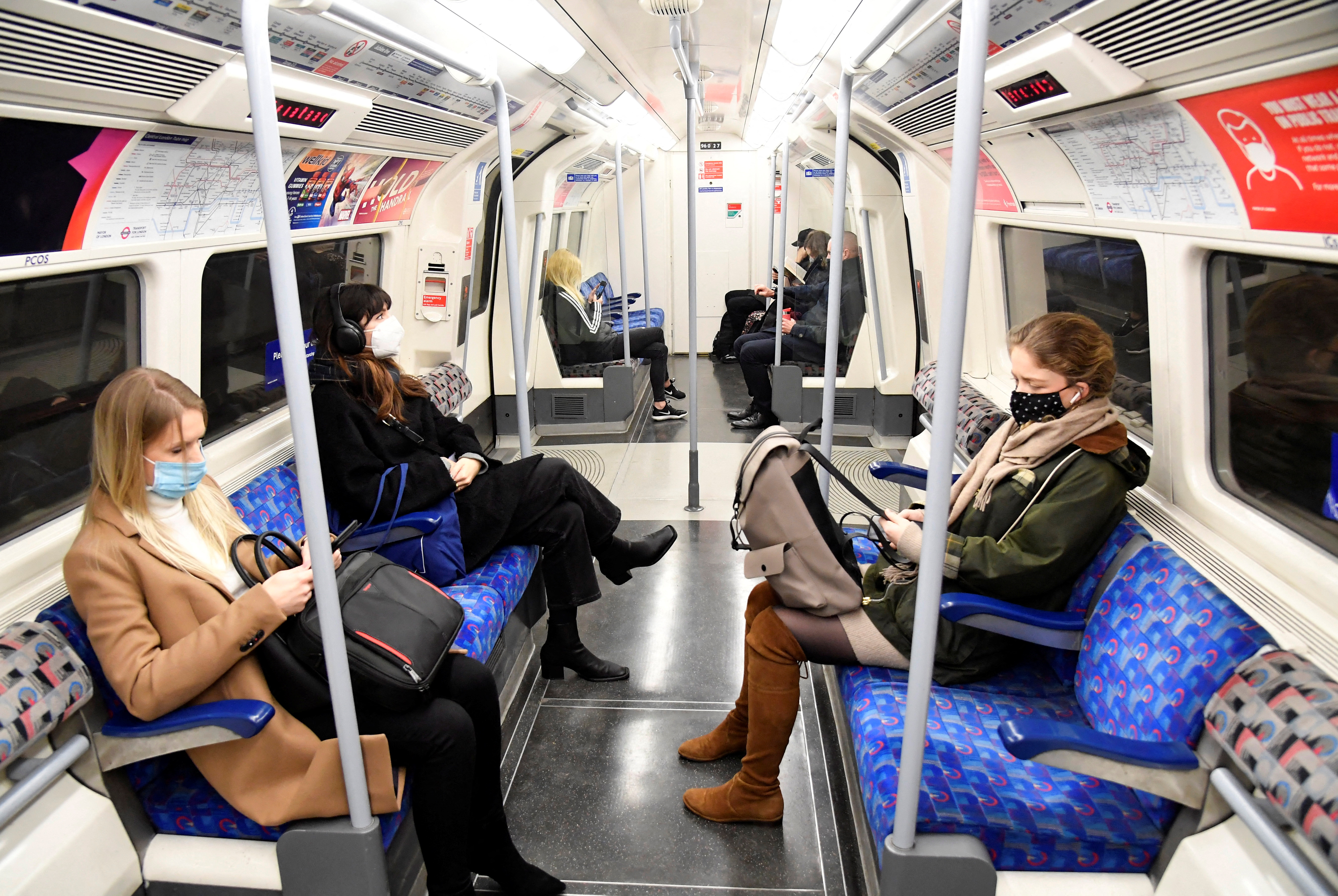 Workers travel on a Jubilee Line underground train during the morning rush-hour, in London