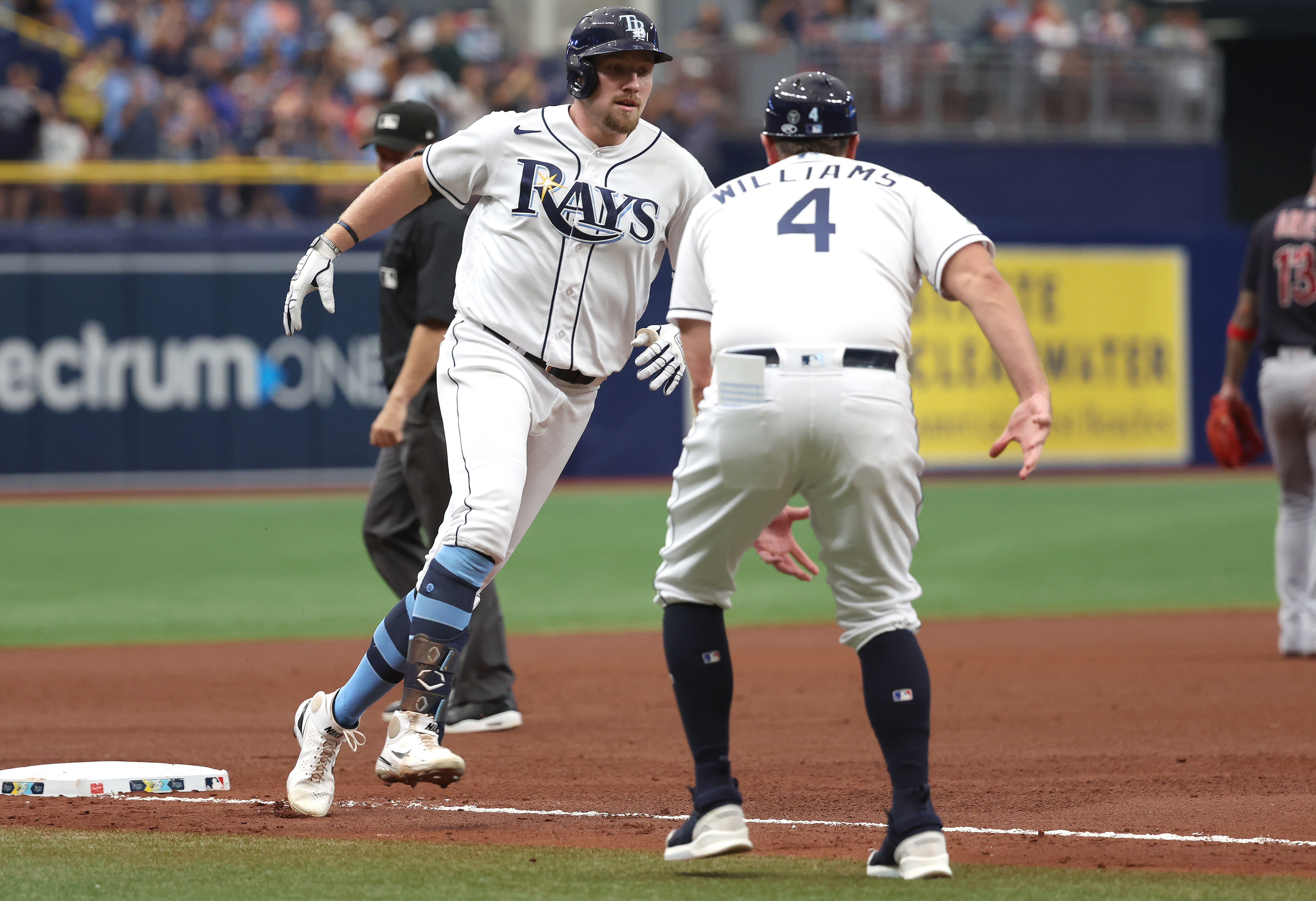 Tampa Bay Rays' Randy Arozarena is congratulated by teammates after scoring  the in the ninth inning of a baseball game against the Cleveland Indians,  Friday, July 23, 2021, in Cleveland. (AP Photo/Tony