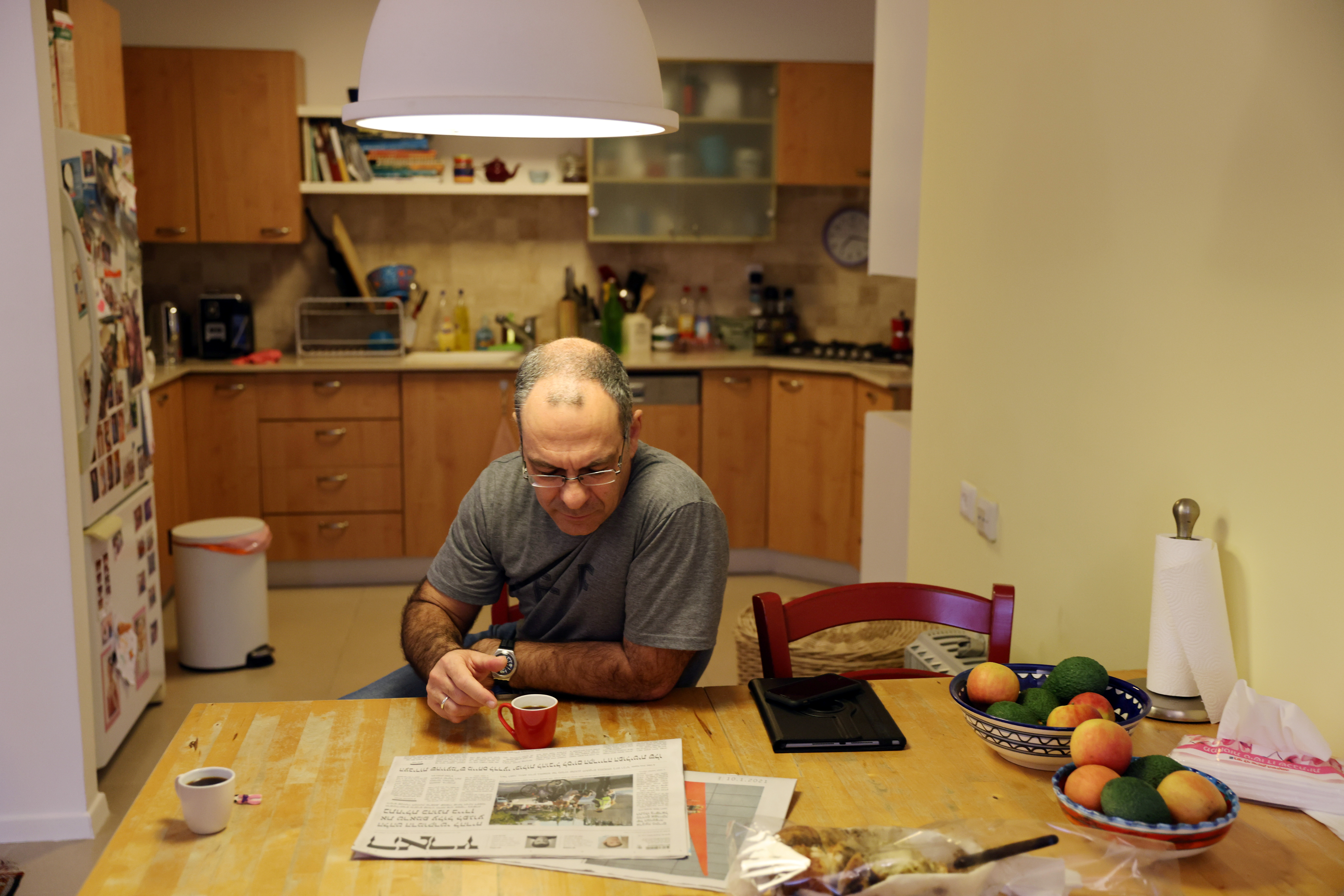 Doctor Guy Choshen drinks coffee at his home before heading to work as director of the COVID-19 ward in Ichilov Hospital in Tel Aviv