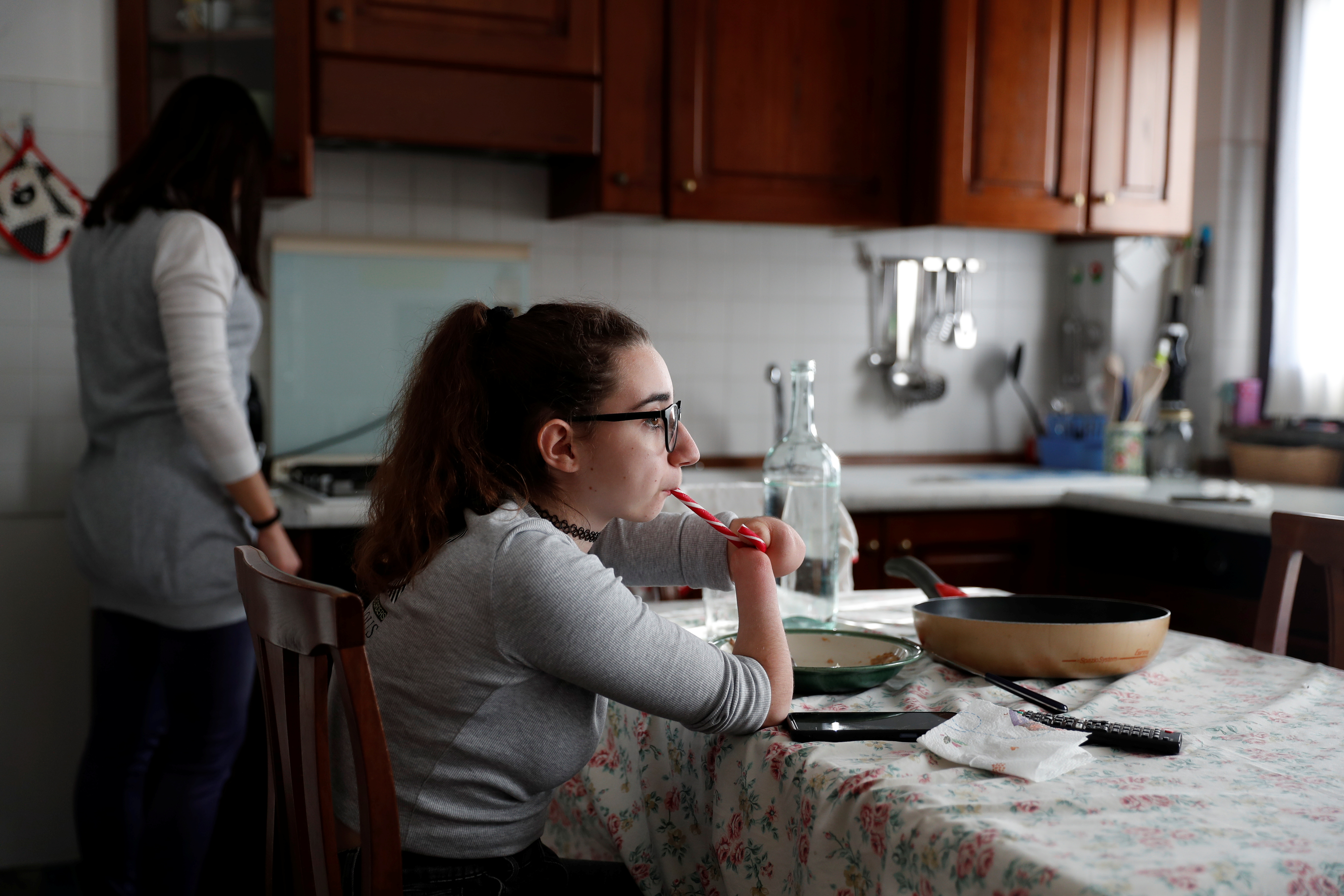 Francesca Cesarini, 15, eats candy after lunch at her home in Magione, near Perugia, Italy, November 15, 2021. Cesarini was born with no hands and with only one leg so her mother was more than a bit surprised when her daughter told her she wanted to be an acrobatic pole dancer. 