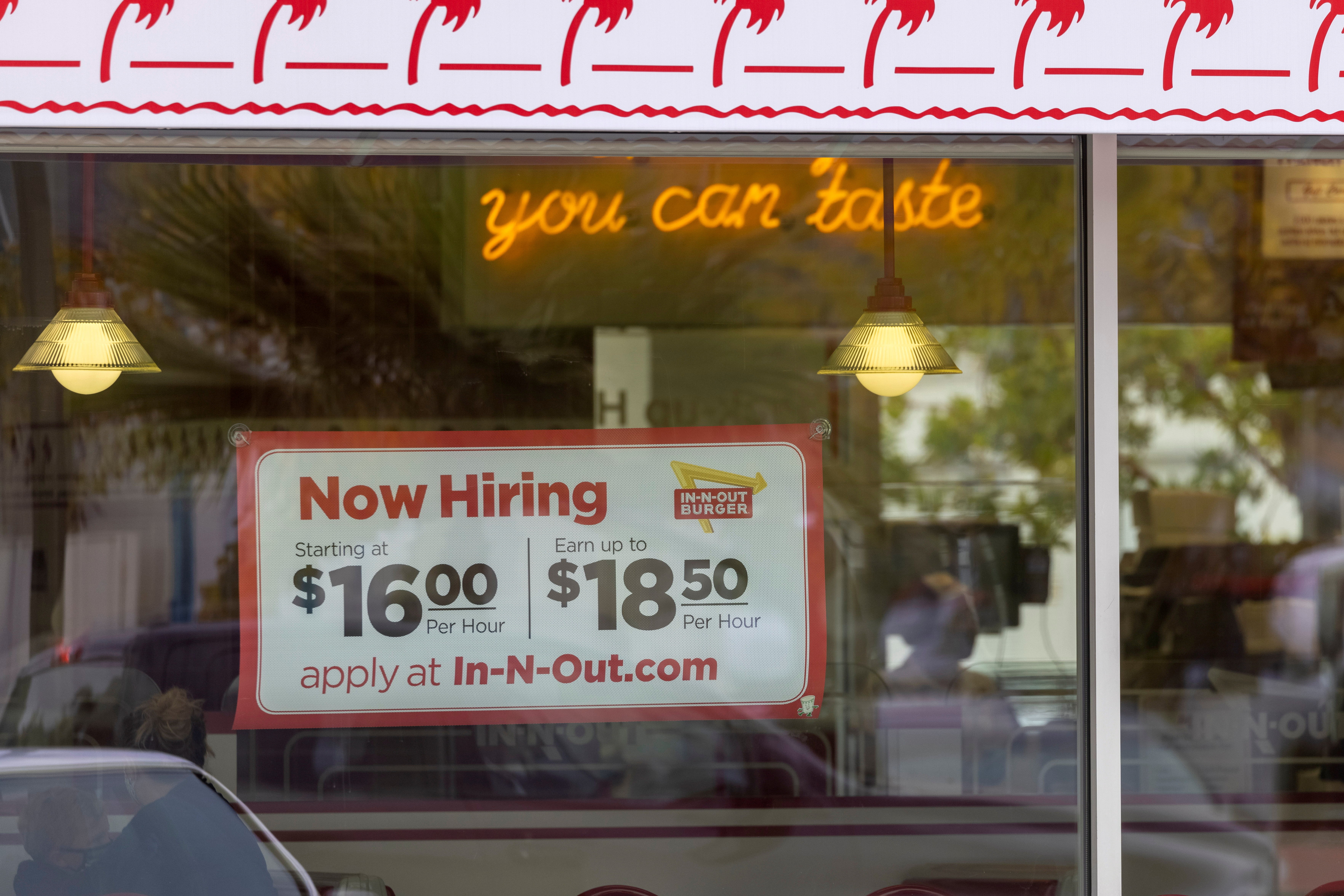An In-N-Out Burger advertises for workers at their restaurants location in Encinitas, California, U.S., May 10, 2021. REUTERS/Mike Blake/File Photo