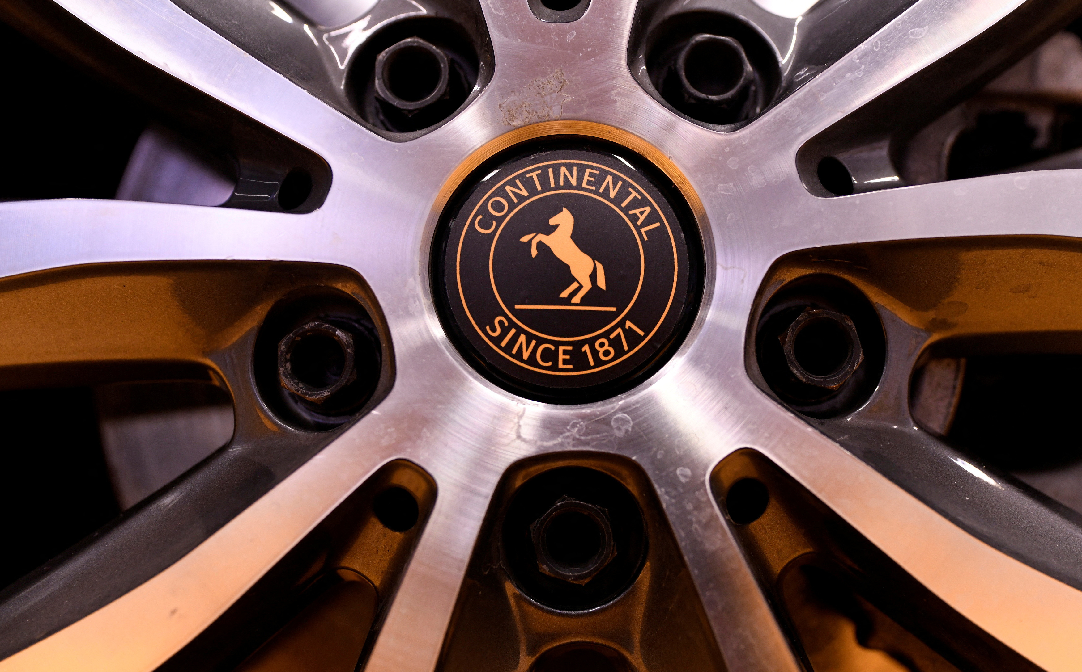 A car wheel with a badge showing the logo of German tyre company Continental