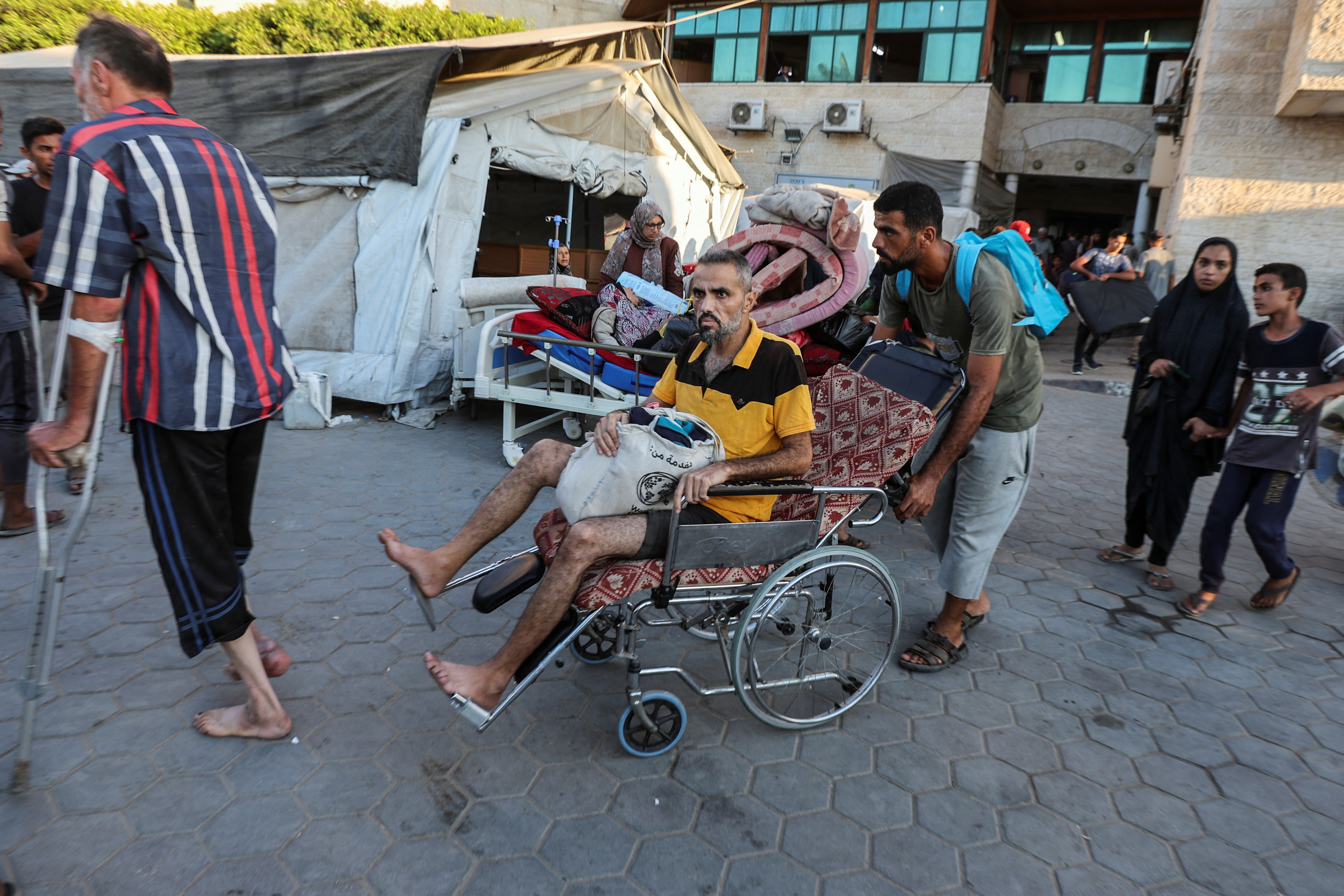 Palestinian patients flee Al-Aqsa Martyrs hospital, in Deir Al-Balah