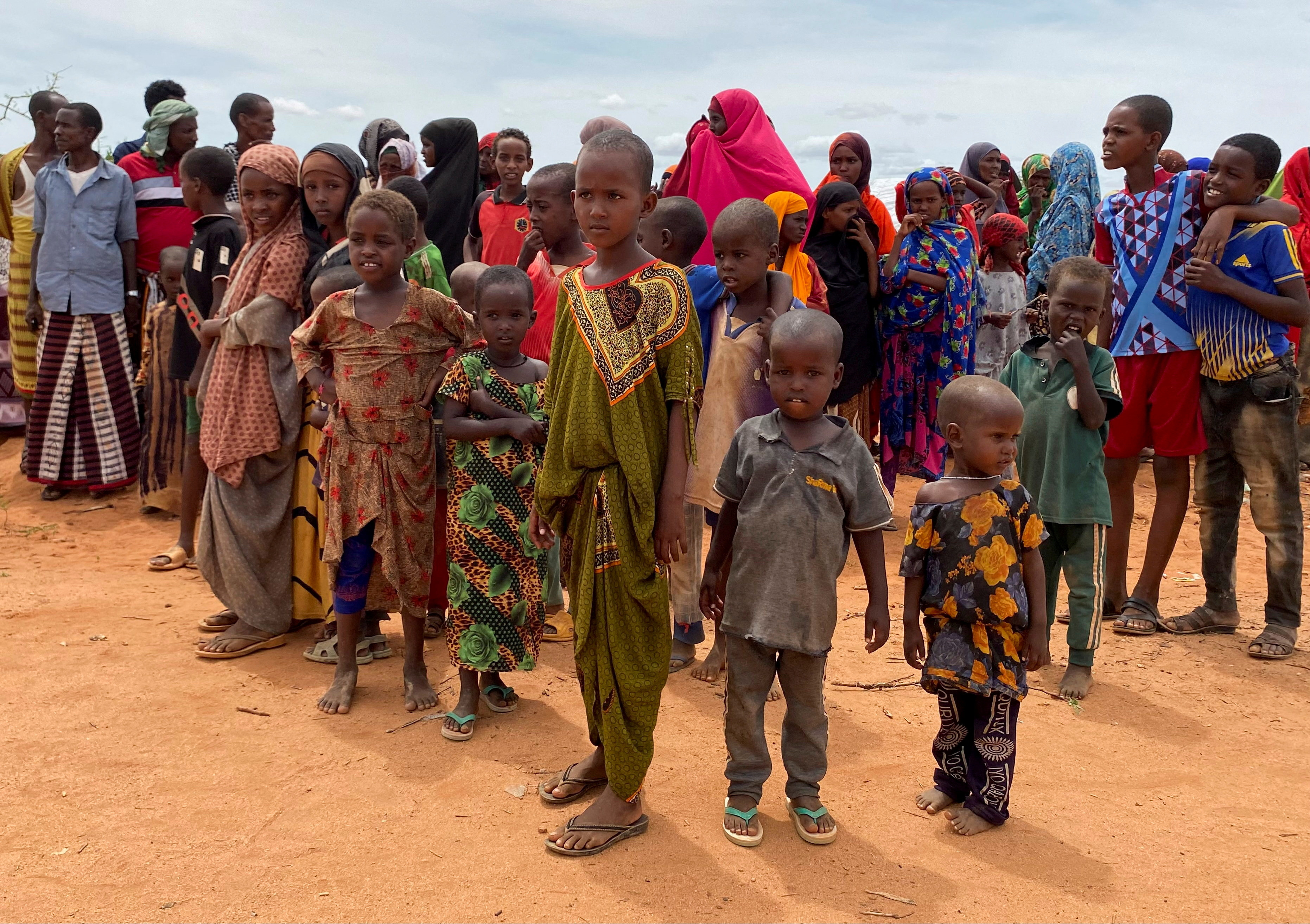 Internally displaced Somali children gather outside their makeshift shelters at the Ladan camp in Dollow