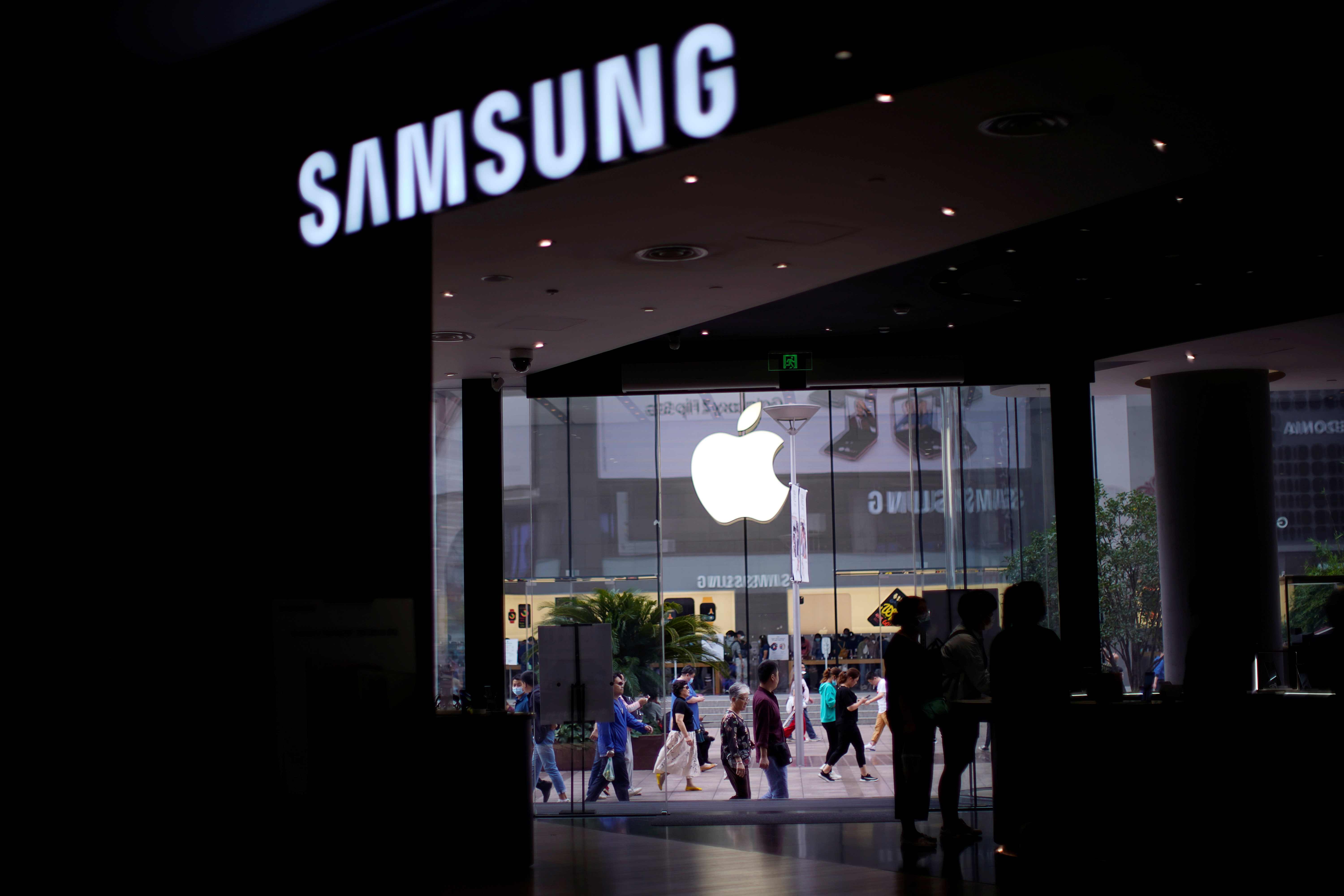Logos of Apple and Samsung are seen at a main shopping area following the coronavirus disease (COVID-19) outbreak in Shanghai