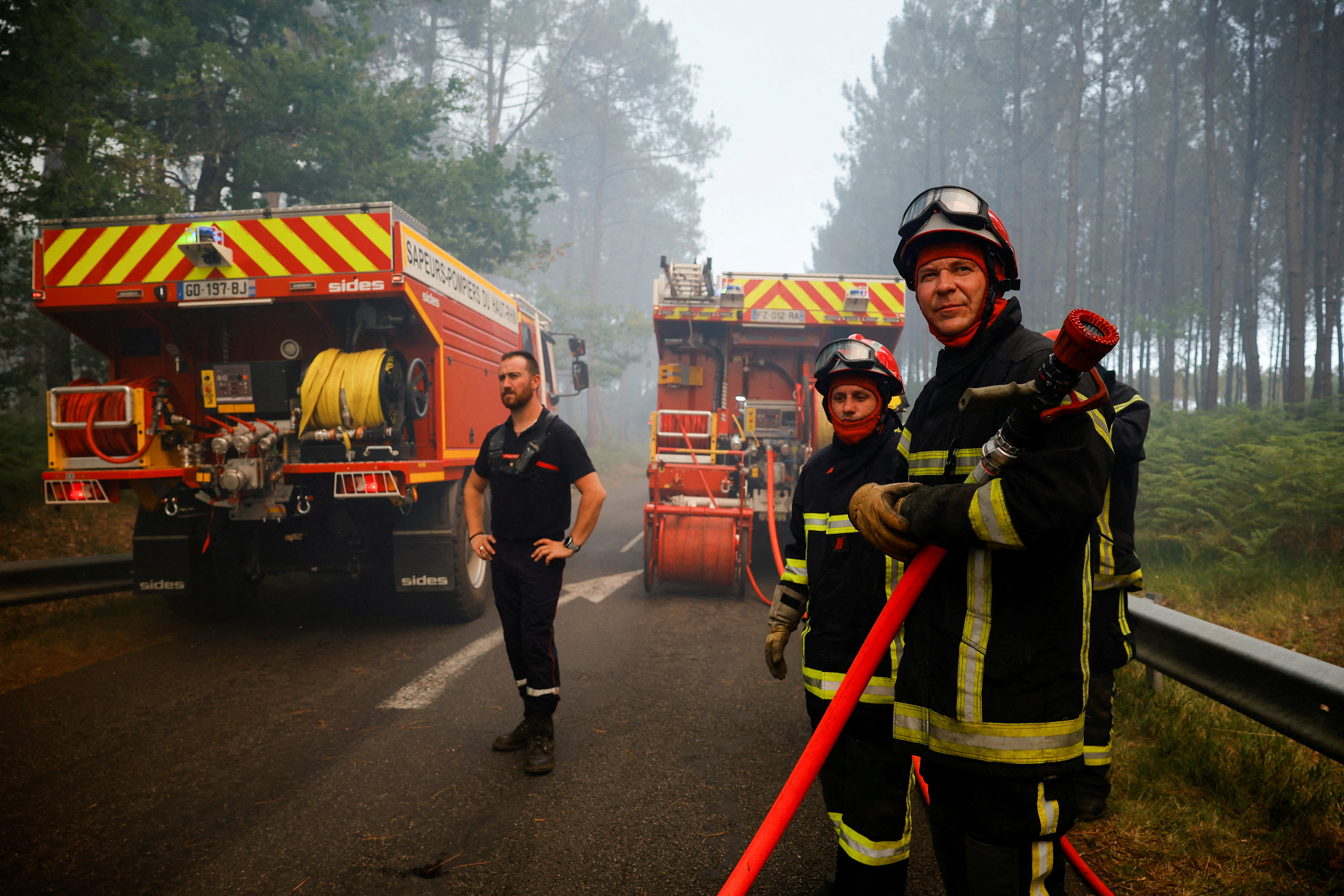 Firefighters work to contain a fire in Guillos, as wildfires continue to spread in the Gironde region of southwestern France