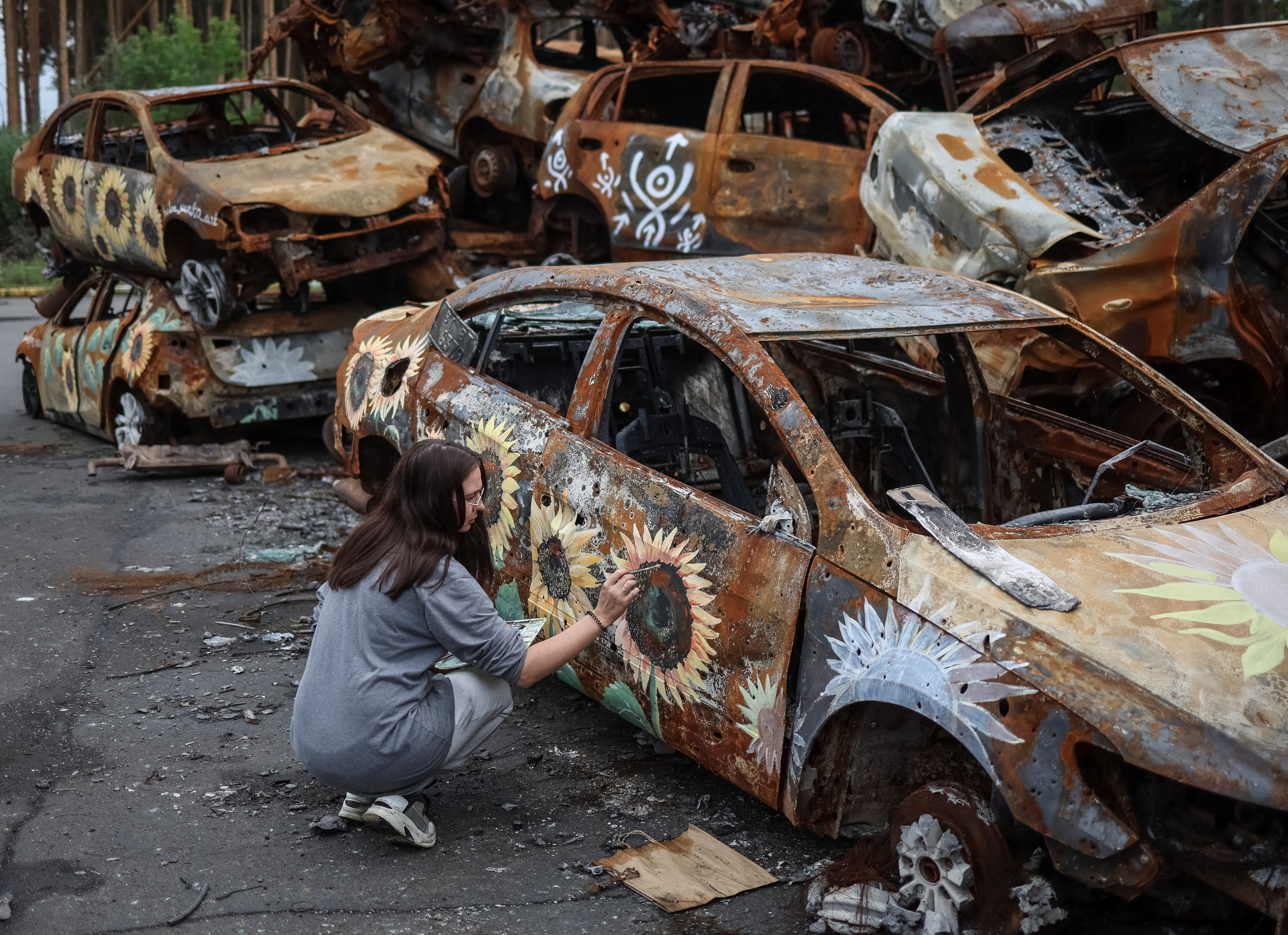 Artists painte cars destroyed during Russia's attack on Ukraine in Irpin
